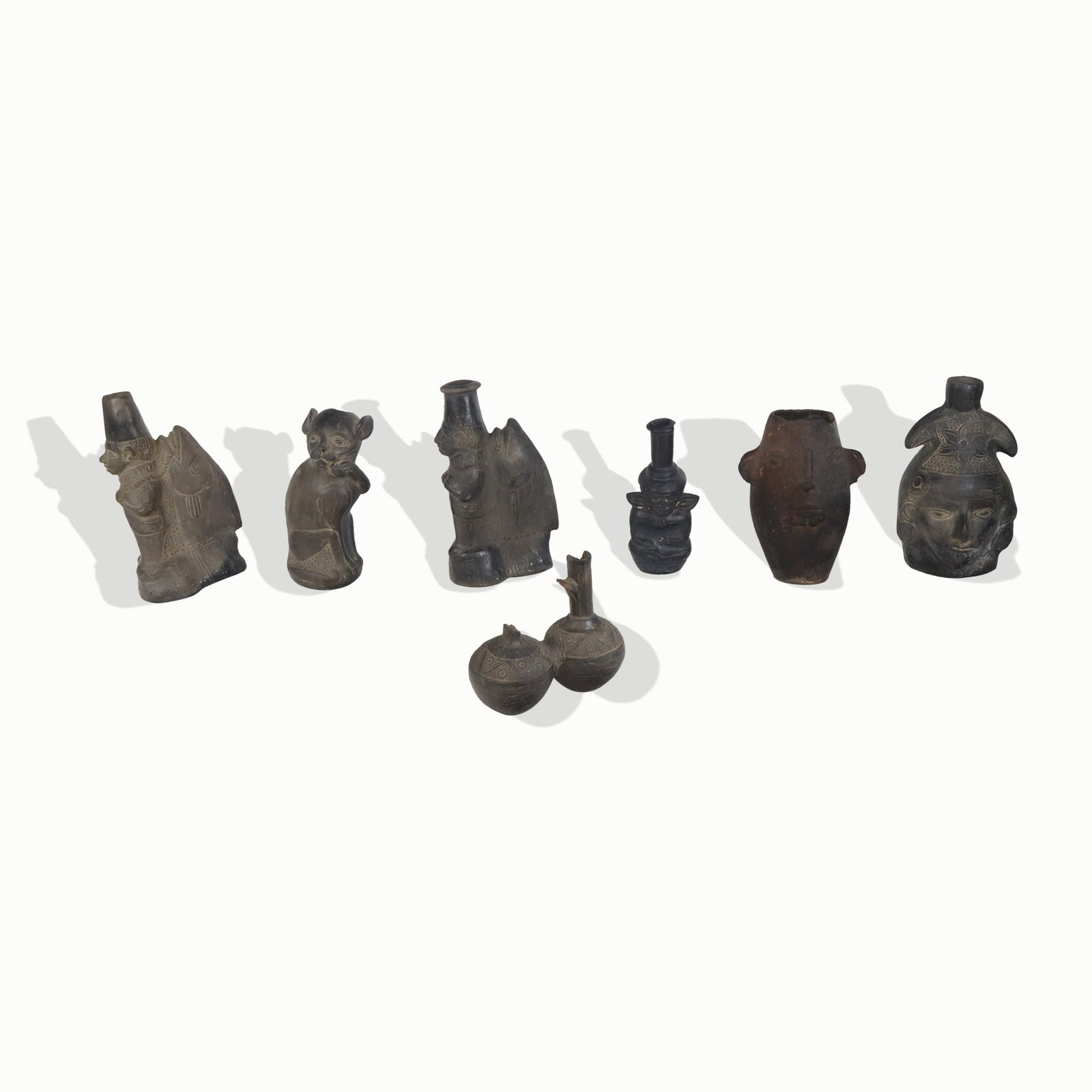 7 Assorted Black Ceramic Ethnographic Vessels: Seven black ceramic ethnographic vessels in various animal and other subject manners. Incised designs and themes. Tallest 10". Various chips and damages.
