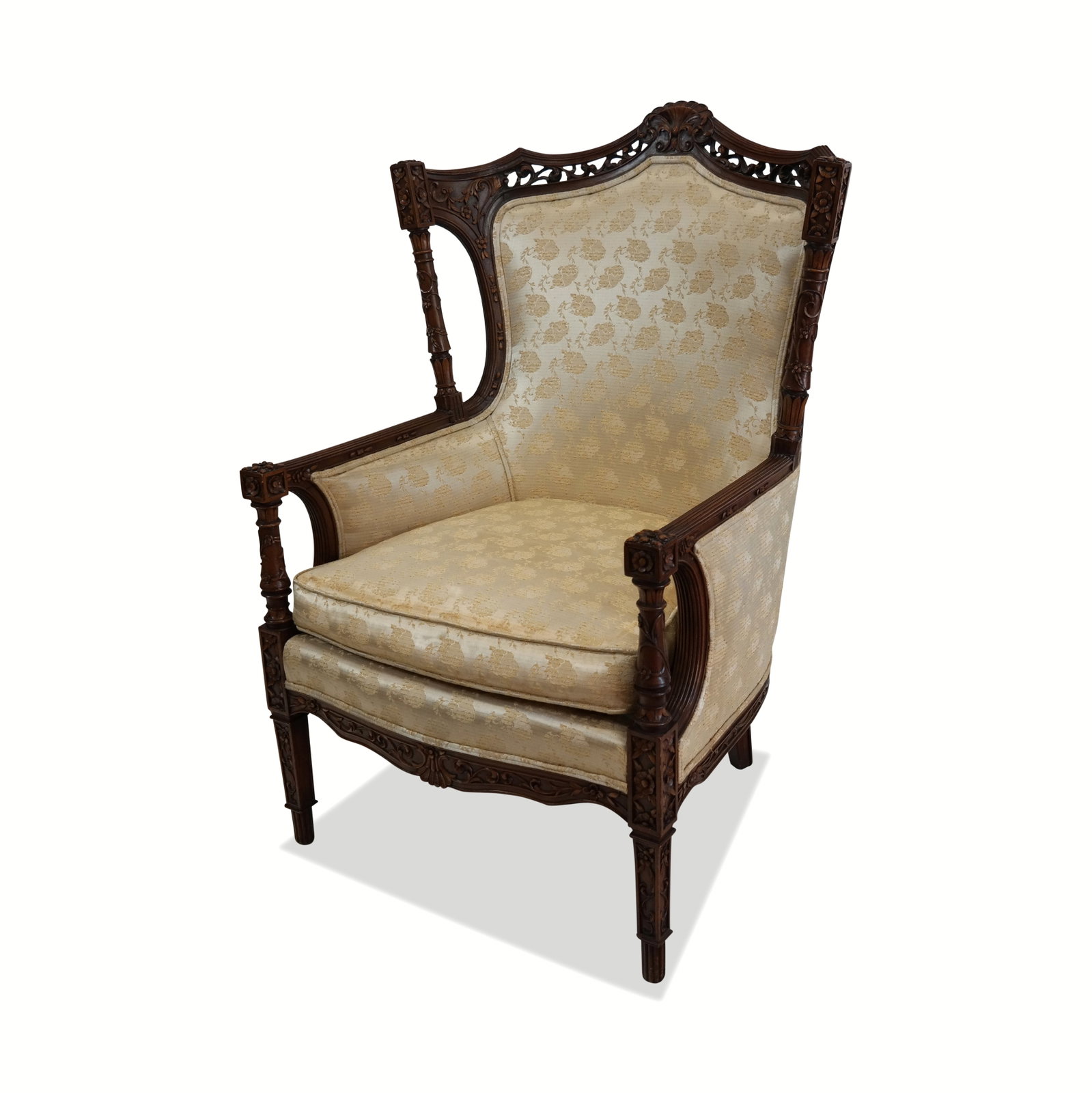English Carved Open Wing Fireside Arm Chair: English carved open wing fireside arm chair with heavily carved mahogany frame, yellow embroidered upholstery and pad cushion seat. 46" H x 32" x 32". Very good and sturdy condition, mars on back of b