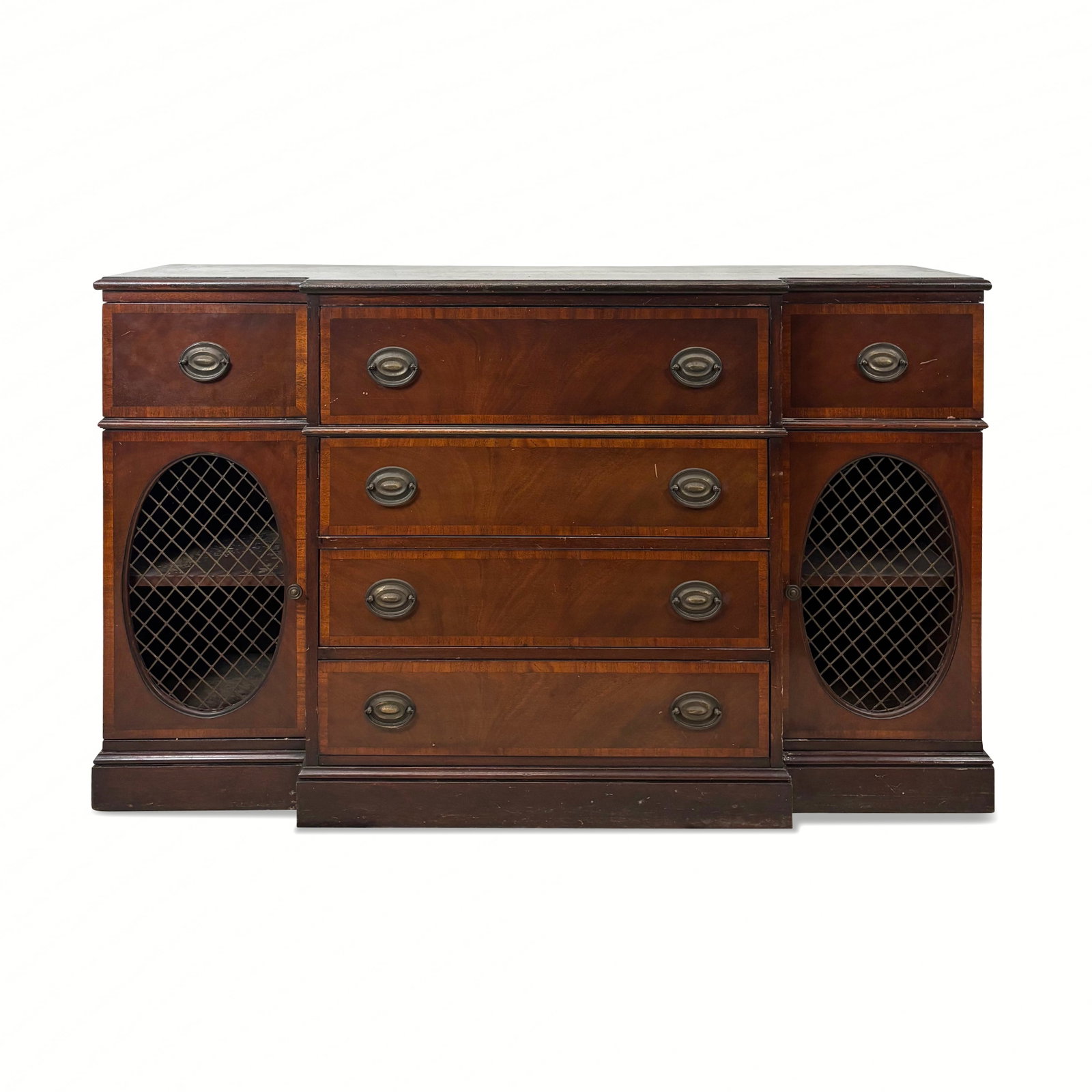 Mahogany Butler's Sideboard: English manner butlers sideboard, with butler's top center drawer, cross banded drawer fronts, and 2 lower grille doors. 36" H x 58" W x 17" D. Fair condition, surface wear and interior scratches and 