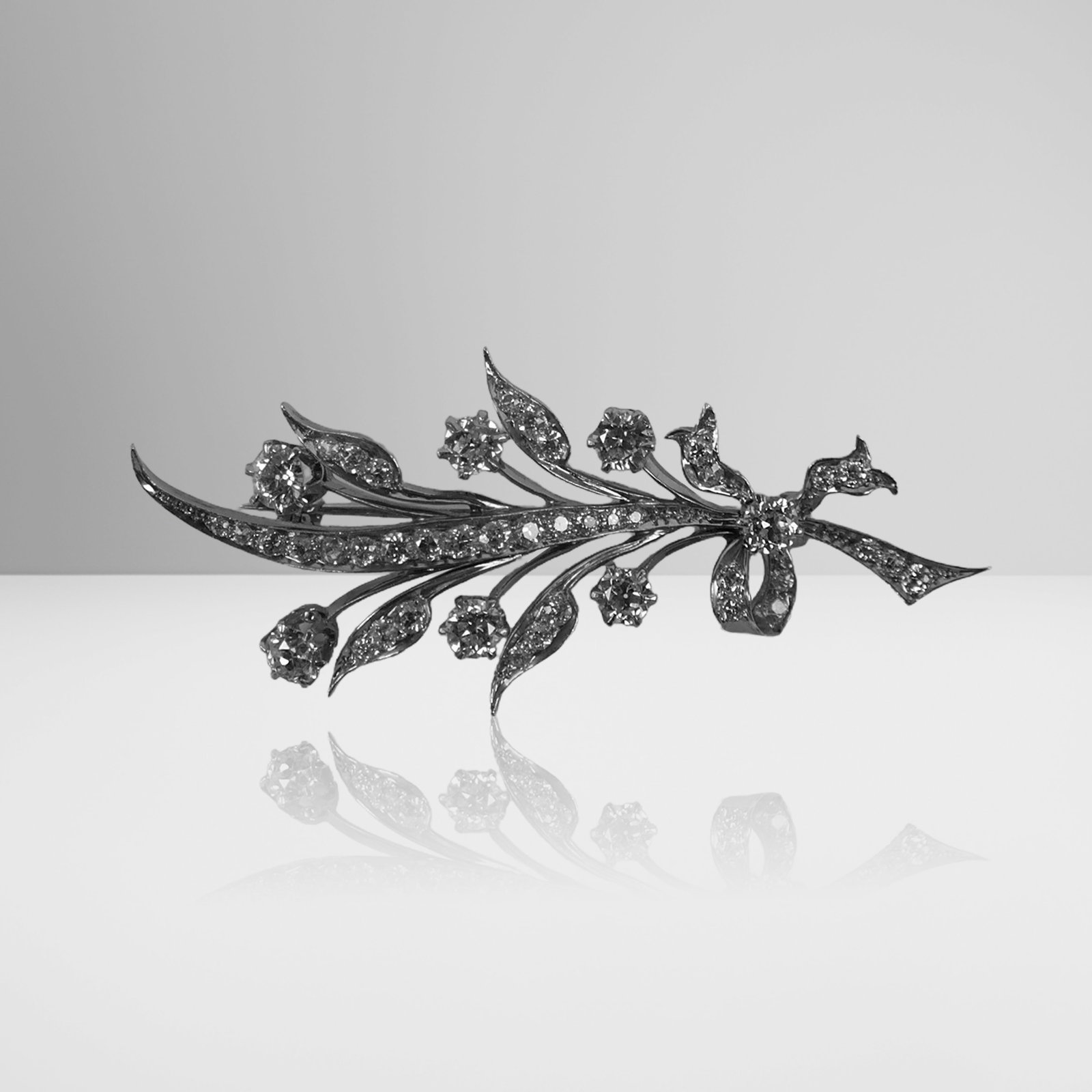 Tiffany & Co. Antique Diamond Foliate Brooch: Tiffany & Co. antique diamond and platinum-topped yellow gold brooch, American, 1895-1905, 45 old mine diamonds, total approximately 2.10 carats, signed Tiffany & Co. on pin stem. [5.3 dwt., 2.25"