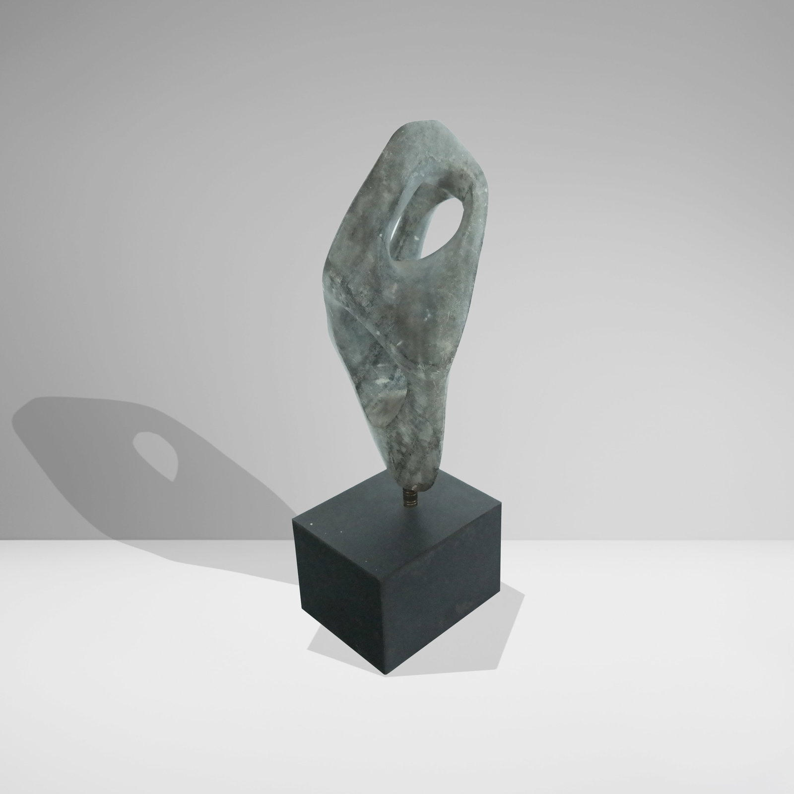 Carved and Polished Stone Sculpture on Stand: Carved and polished stone sculpture, 20th/21st century, on a black painted wood base, unsigned. [16" H x 7.25" W x 4.25" D]. Condition is good with some minor wear to base.