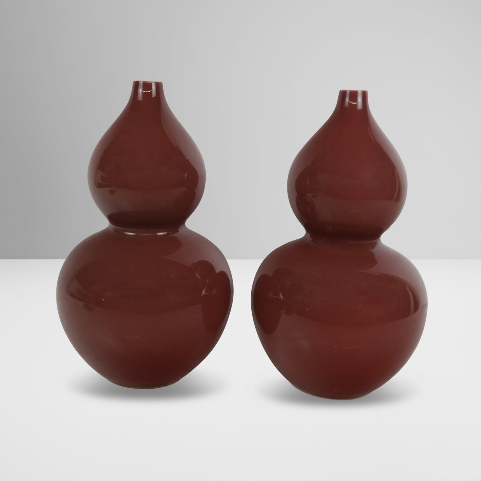 Pair of Chinese Sang de Beouf Double Gourd Vases: Pair of Chinese sang de beouf double gourd vases, 20th century, unmarked. [12" H x 8" Diameter]. Condition to each is good.
