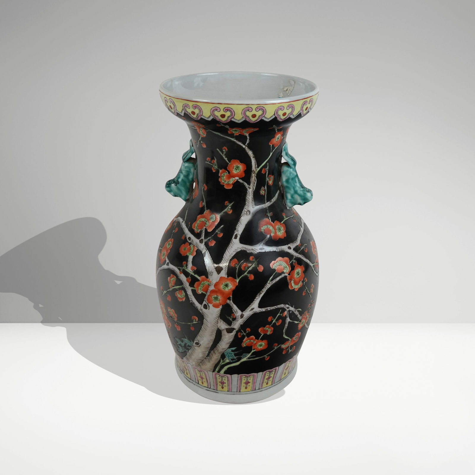 Chinese Famille Noir Vase: Chinese Famille noir vase, 20th century, with hand-applied floral decoration and two foo dog handles, unmarked. [14" H x 8" Diameter]. Condition is good to fair with surface wear.
