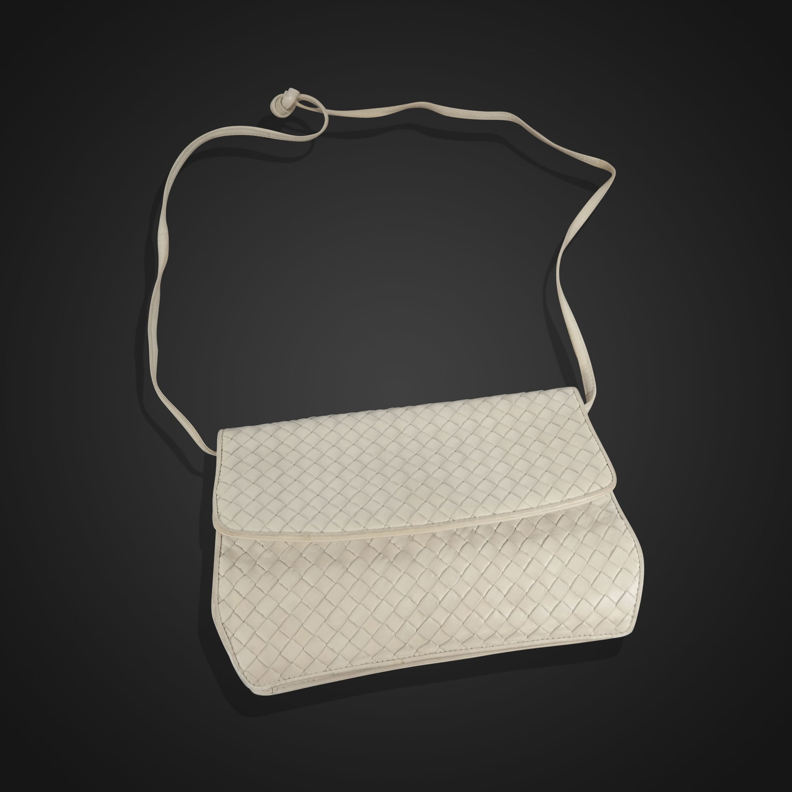 Bottega Veneta Woven Leather Clutch Handbag: Bottega Veneta woven leather clutch handbag, 21st century, with shoulder strap, marked Bottega Veneta to interior label. [Less strap: 7" H x 11" W]. Condition is good with some minor wear.