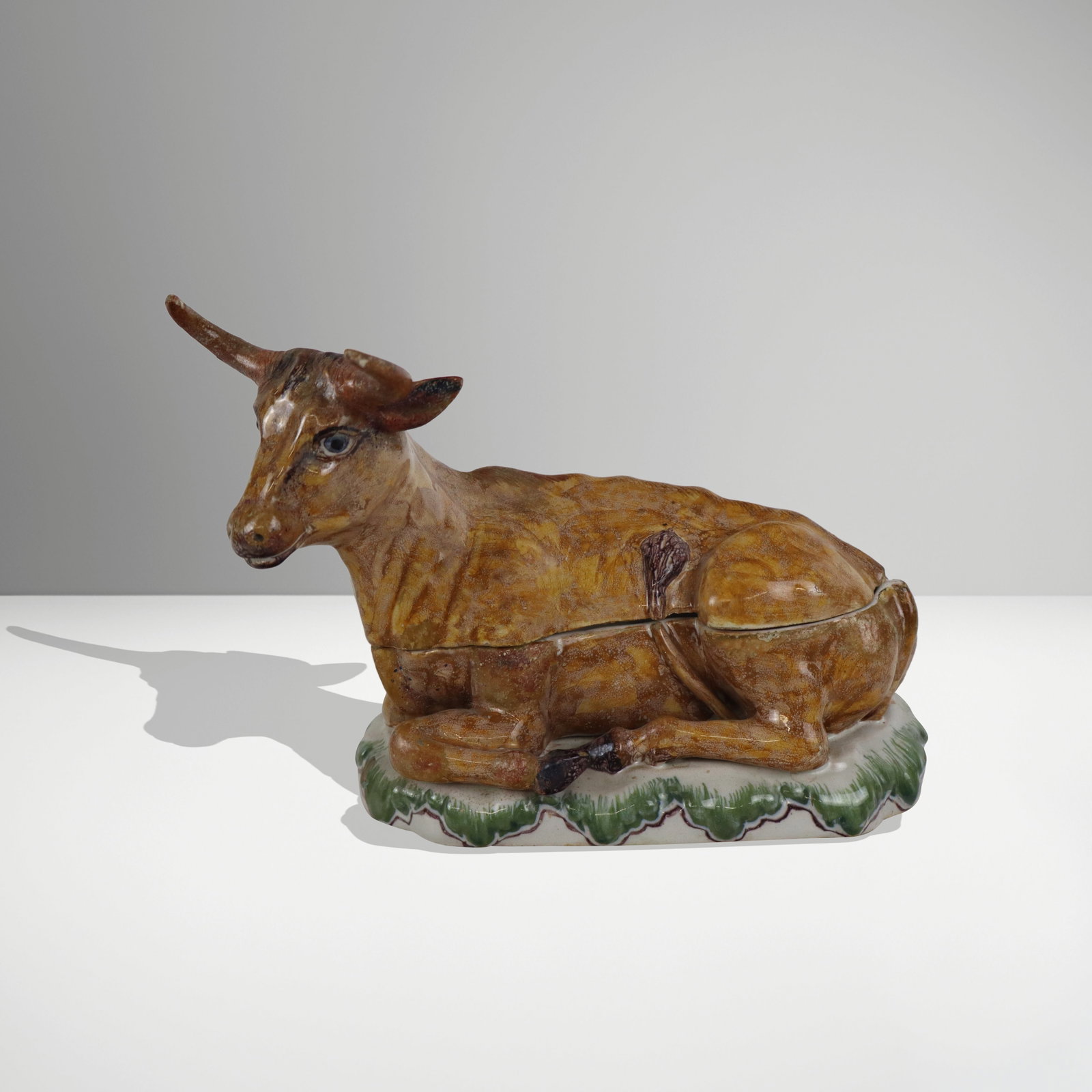 Hand-Painted Porcelain Box in the Form of a Cow: Hand-painted porcelain box, early 20th century, in the form of a cow, marked M to base, with further mark to interior, otherwise unmarked, and with a Christies label to interior. [6.5" H x 9" W x 4.5"