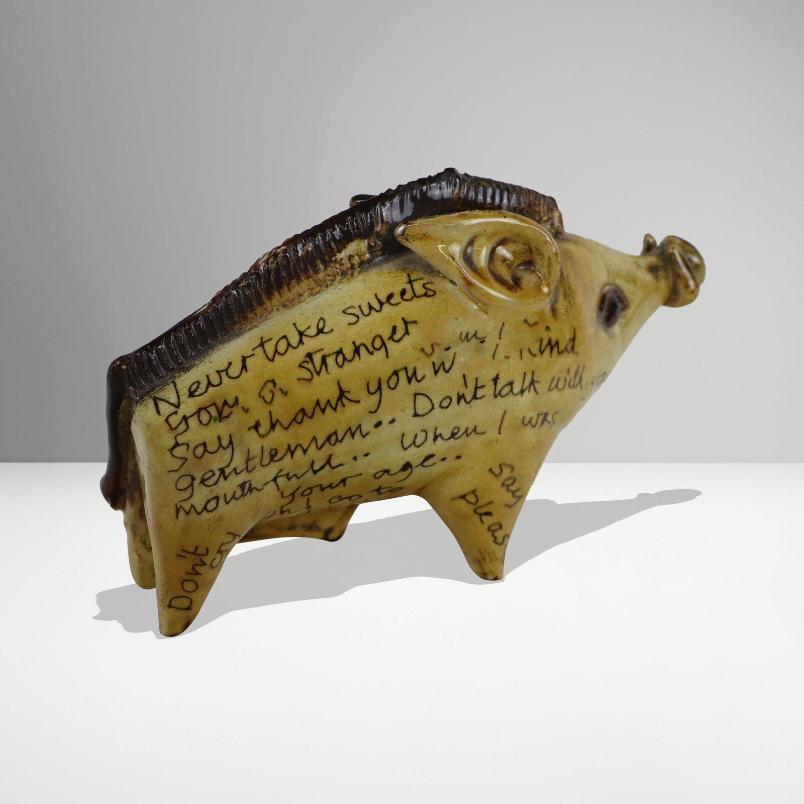 "The Children's Bore" Folk Art Pottery Figure: "The Children's Bore" folk are pottery figure of a boar, 20th century, inscribed to both sides and with hand-painted decoration, otherwise unmarked. [7 H x 4.5" W x 11.5" D]. Condition is good. From t