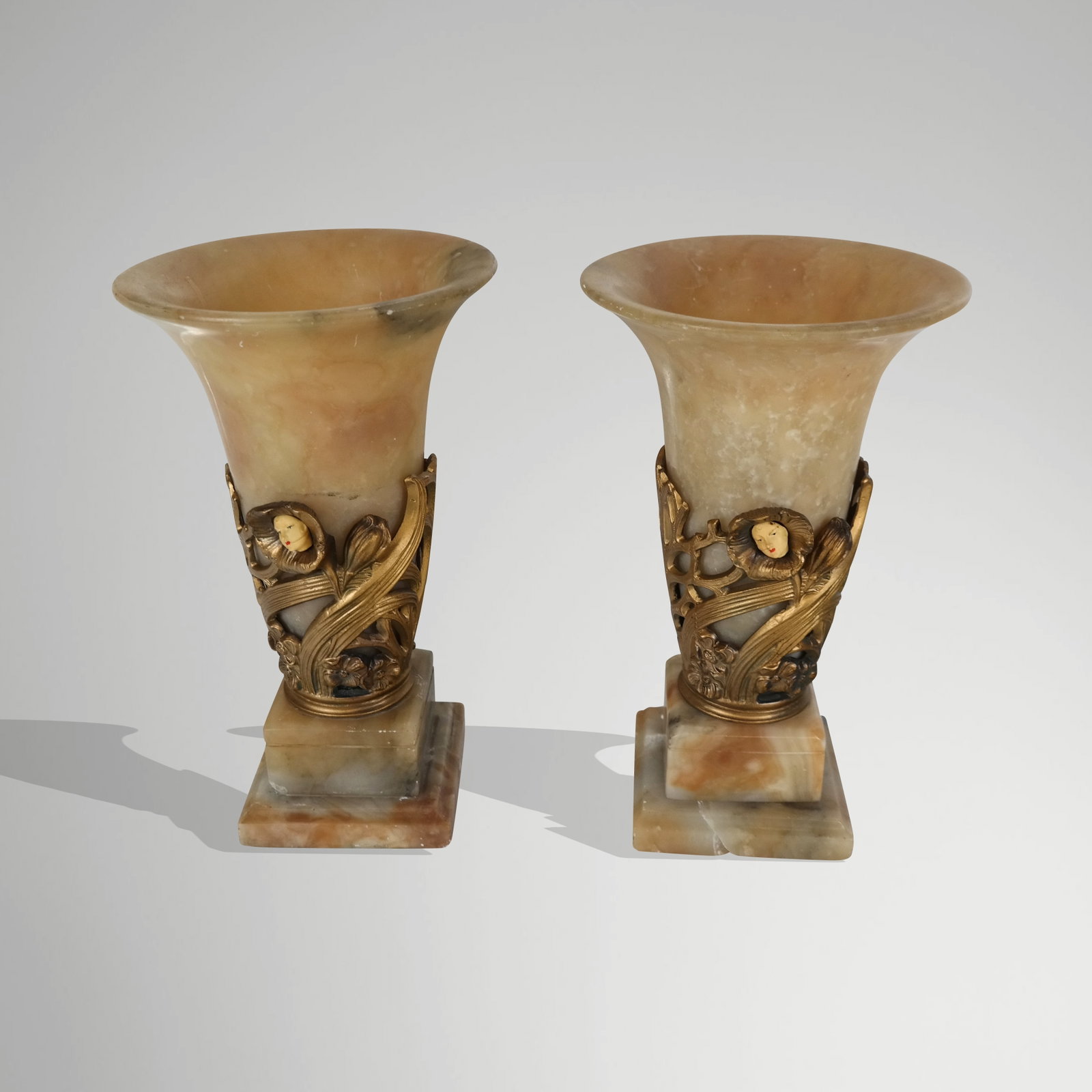 Pair of Onyx and Gilt Decorated Uplights: Pair of onyx and gilt decorated uplights, 20th century, with face detail. [12" H x 7.25" Diameter]. Condition is good to fair with wear, some minor losses, breaks to base of each, and wires cut.