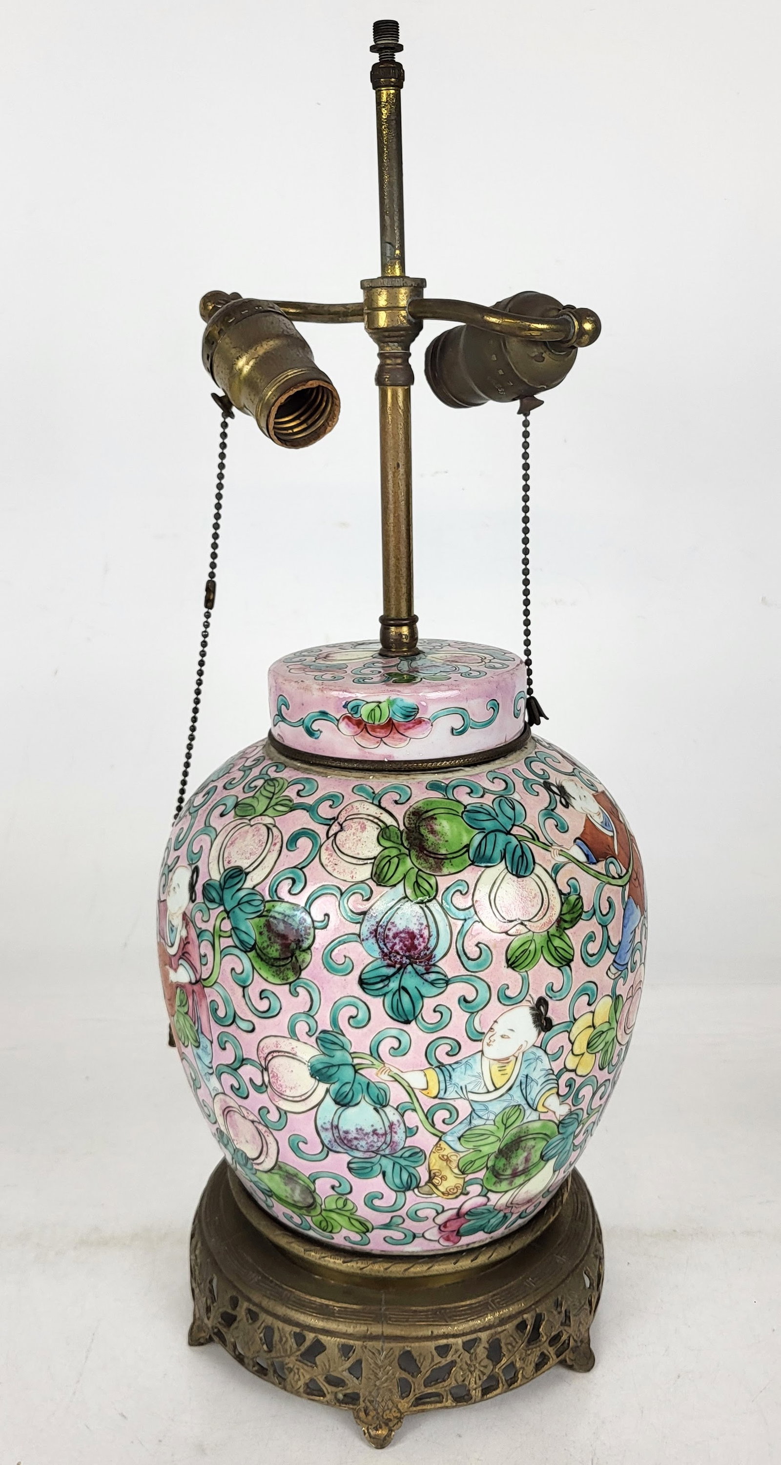 Chinese Decorated Figural Lamp: Chinese lamp depicting figures among flowers on a pink ground. [21.5" H]. No cord; color runs.