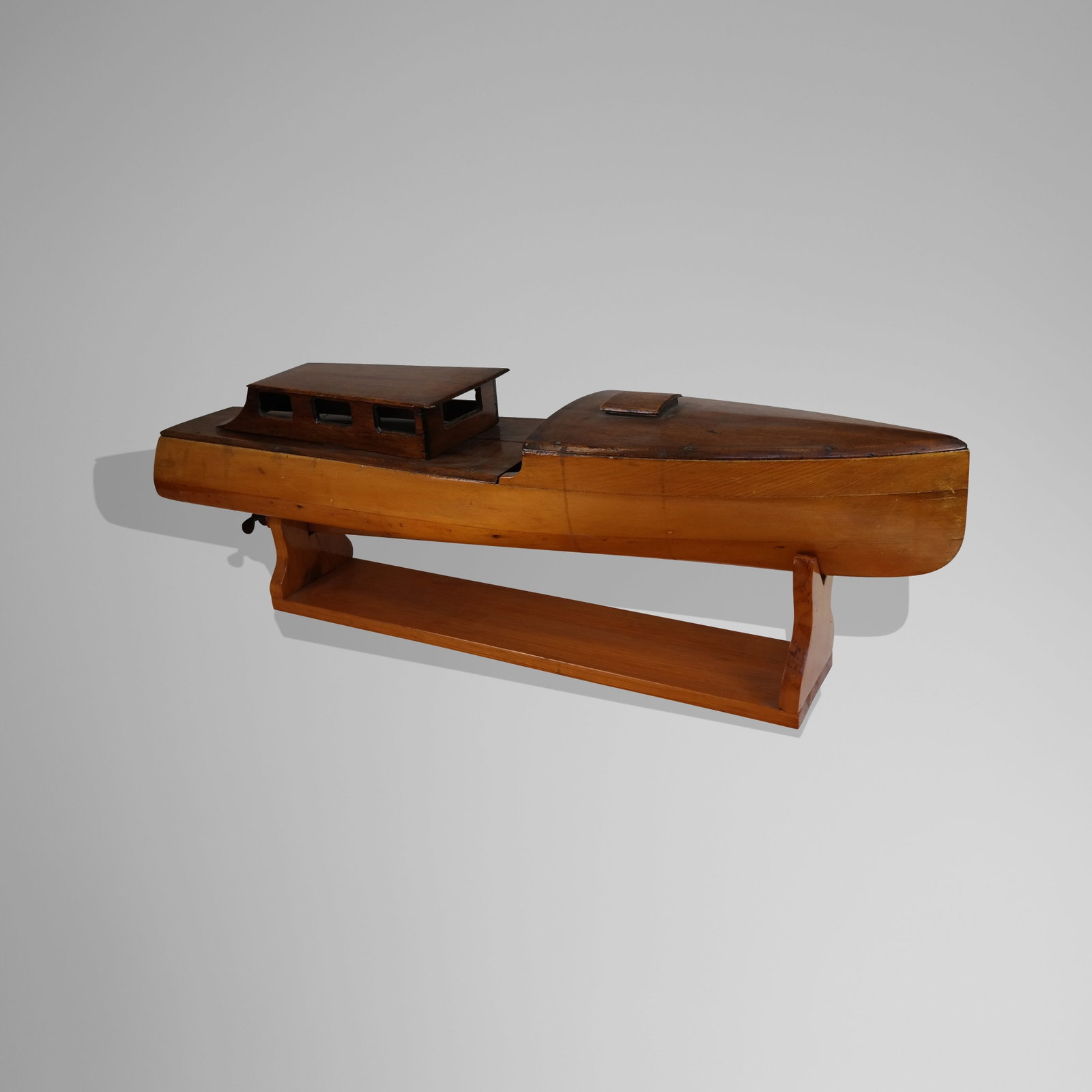 1950's Style Boat Model on Stand: 1950's style boat model on stand, circa 1960's. Mixed woods, brass screws, on separate stand, loose cover. [12" H x 36" L x 9" D]. Good condition, rudder needs attaching.