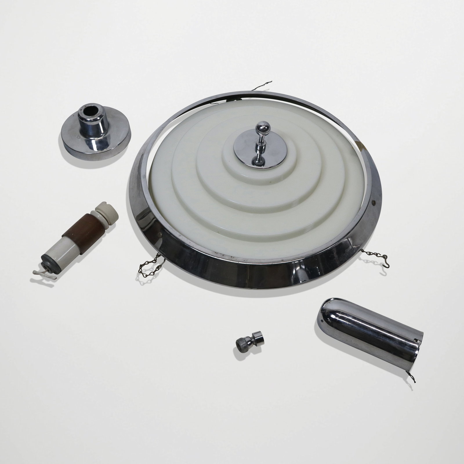 Art Deco Round Light Fixture: Art Deco round light fixture, circa 1960's, of stepped white milk glass supported by chrome round base, en suite with the preceding lot. [4" H x 17" Diameter]. Generally good condition.