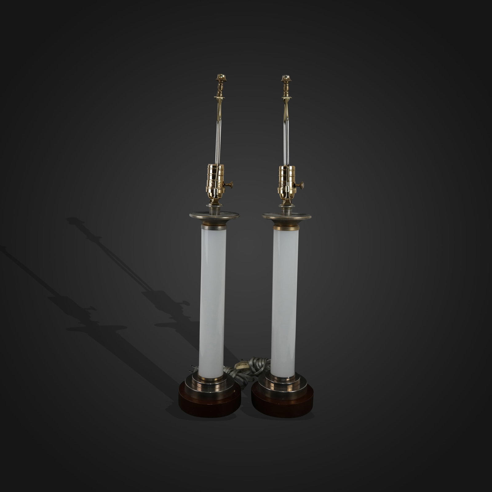 Modern Tubular Milk Glass Post Lamp - Pair: Modern tubular milk glass post lamp, Pair, late 20th century, brushed metal top and bottom collars on wood bases. [26" total height x 5.5" diameter]. Good condition, slight chips on wood base.