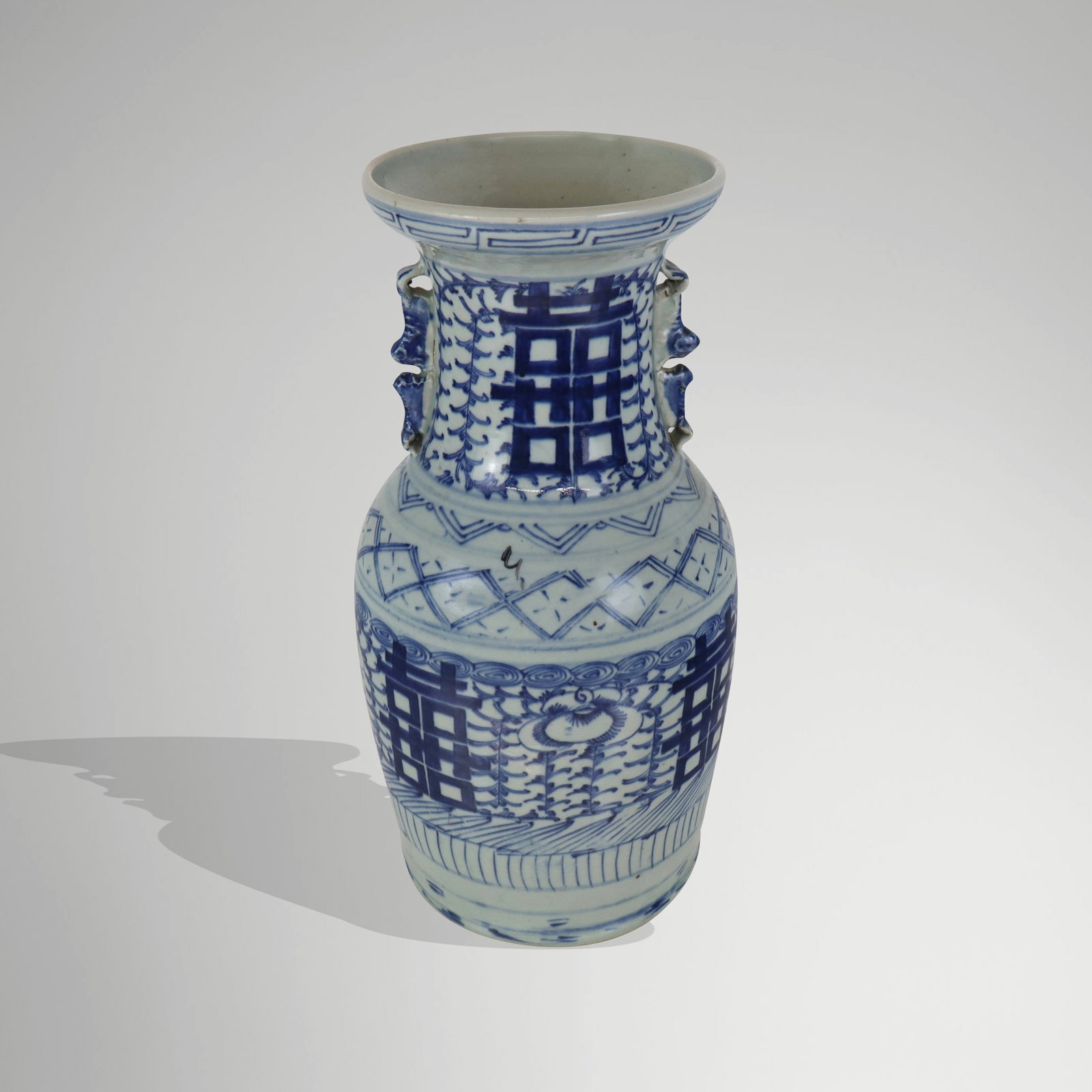 Chinese Qinghua & Double Happiness Decorated Vase: Chinese Qinghua decorated vase, 20th century, with Double Happiness detail and two handles to upper and hand-applied decoration, unmarked. [16" H x 9" Diameter]. Condition is good with some crazing.