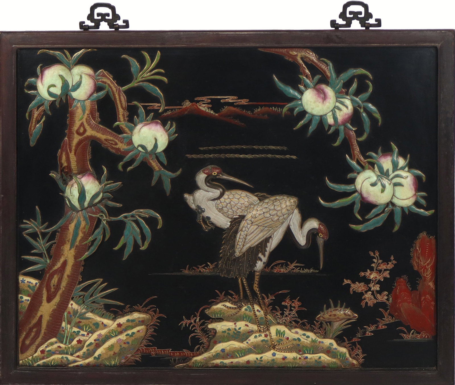 Chinese Cloisonne on Panel with Cranes and Peaches: Chinese cloisonne on panel, 20th century, with elaborate landscape and crane decoration with peaches, on a hand-painted and gilt decorated ground, in a rosewood frame, unmarked. [35" H x 42.5" W]. Con