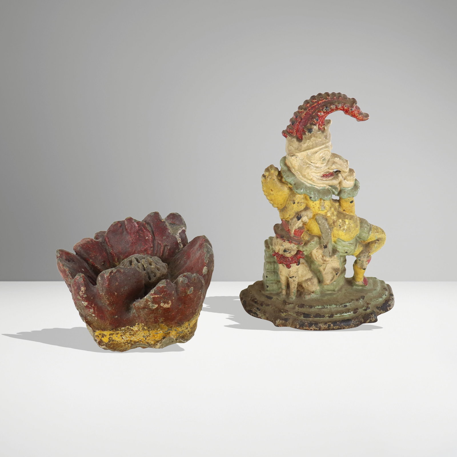 Two door stoppers, 20th century, comprising a painted concrete floriform door stopper, and a painted (1 of 9)