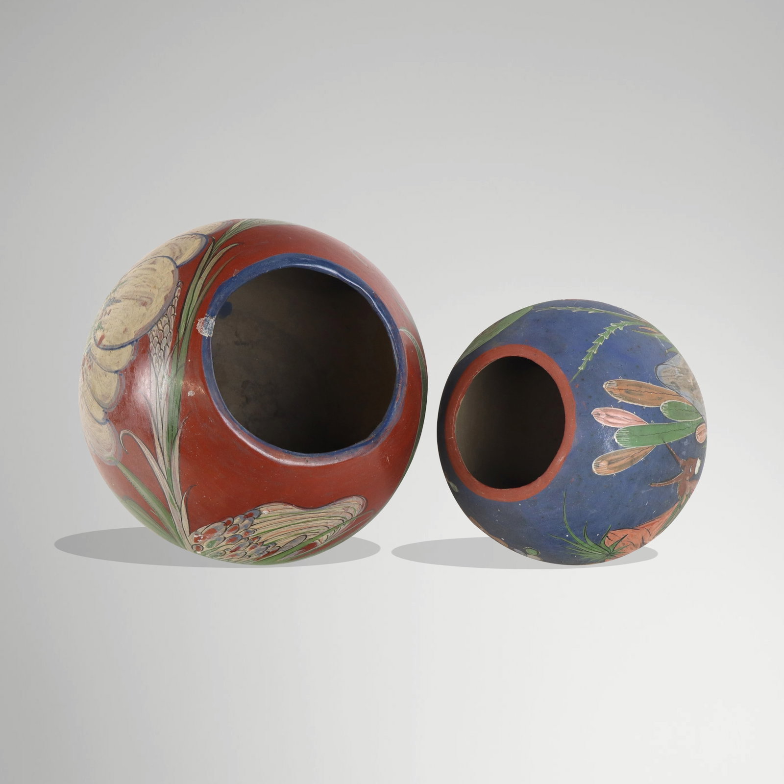 Two Mexican hand-painted terra cotta vases, circa 1930s, one marked Made in Mexico to base, other: Two Mexican hand-painted terra cotta vases, circa 1930s, one marked Made in Mexico to base, other unmarked. [Larger: 10.5" H x 12" Diameter]. Condition to each is good with age-commensurate surface