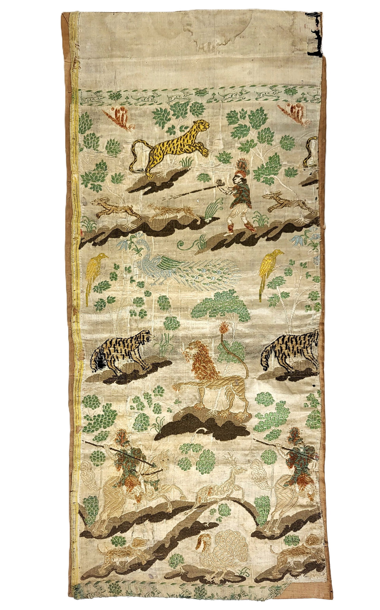 17th Century Spanish/Portuguese Panel: Spanish/Portuguese panel; 17th century, in brocade fine silk, depicting scenes of hunters and deer, lions and tigers, a peacock, and leopard. 16" x 36". Age losses and tears and worn.