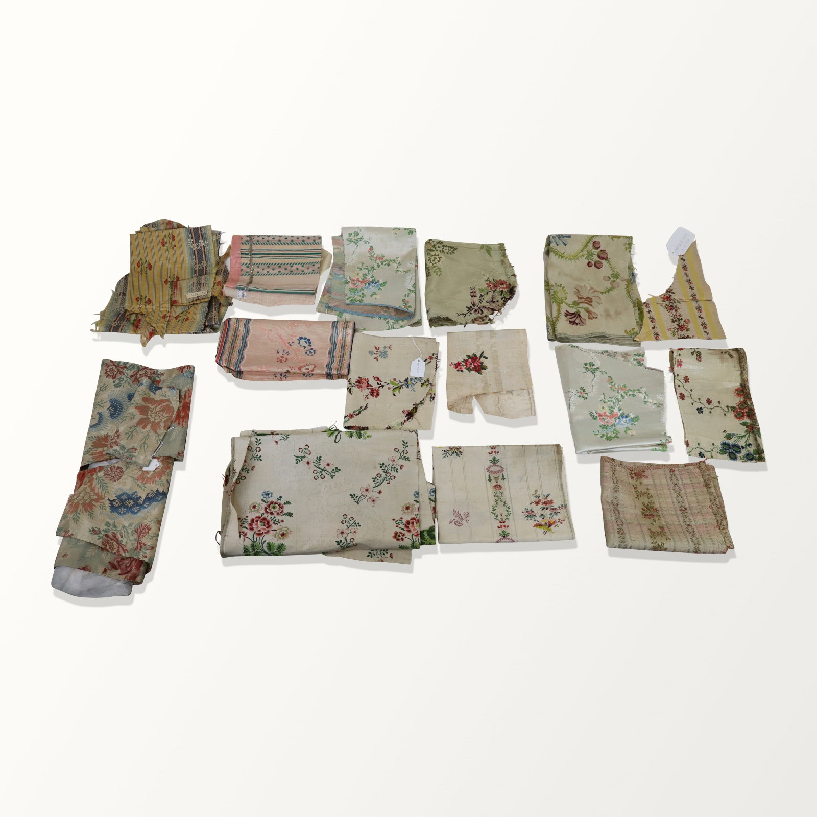 European Fine Silk Brocade Fragments: Silk fragments, 18th and 19th century, some very fine brocade silk and colorful flowers. Frayed, aged, worn.