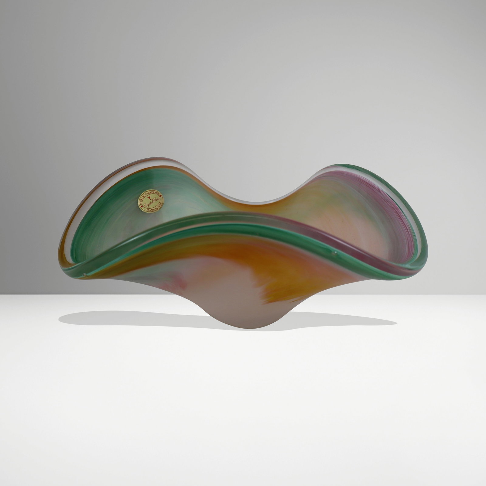 Murano Art Glass Center Bowl: Murano pastel art glass center bowl, bearing label "Murano Glassware Crystal Clear Made In Italy". [4.75" H x 10" Square]. Overall condition is good, with little wear.
