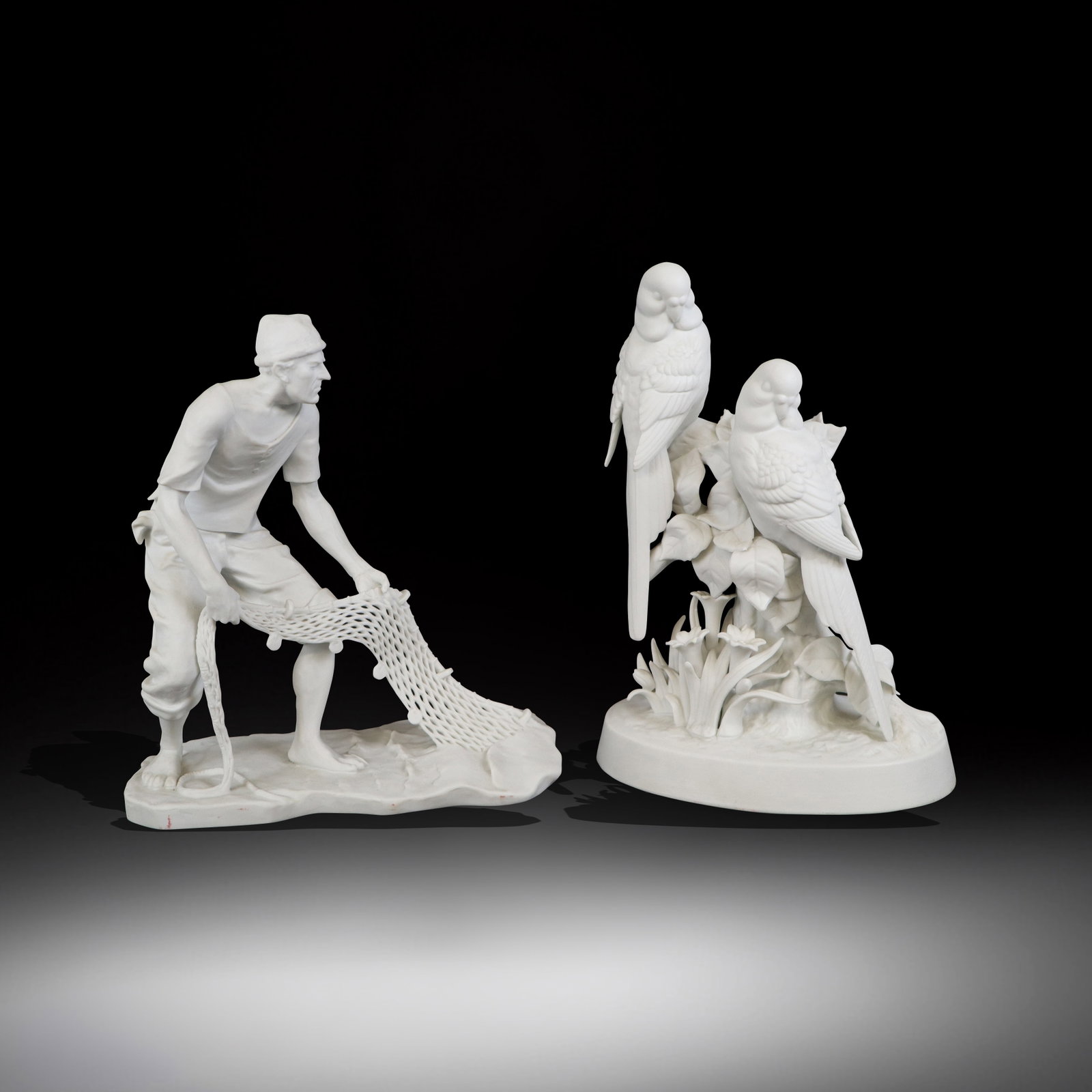 Vista Alegre & Other Parian Figure Groups, 2: Two Parian figural groups comprising a Vista Alegre "River Fisherman" figurine [9.25" H x 8.25" W x 3.75" D, and a figurine of two birds resting on a foliate cluster [10" H x 6.75" W x 4.5" D], signed