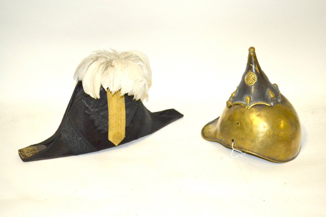 Two Military Helmets: One Napoleonic style, the other brass.