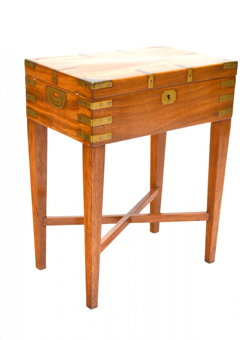Campaign Box on a Stand: Walnut campaign box; x-stretcher base, brass bound with two handles. (Base and top are one piece.) In good condition. [11" x 17" x 21 3/4" H]