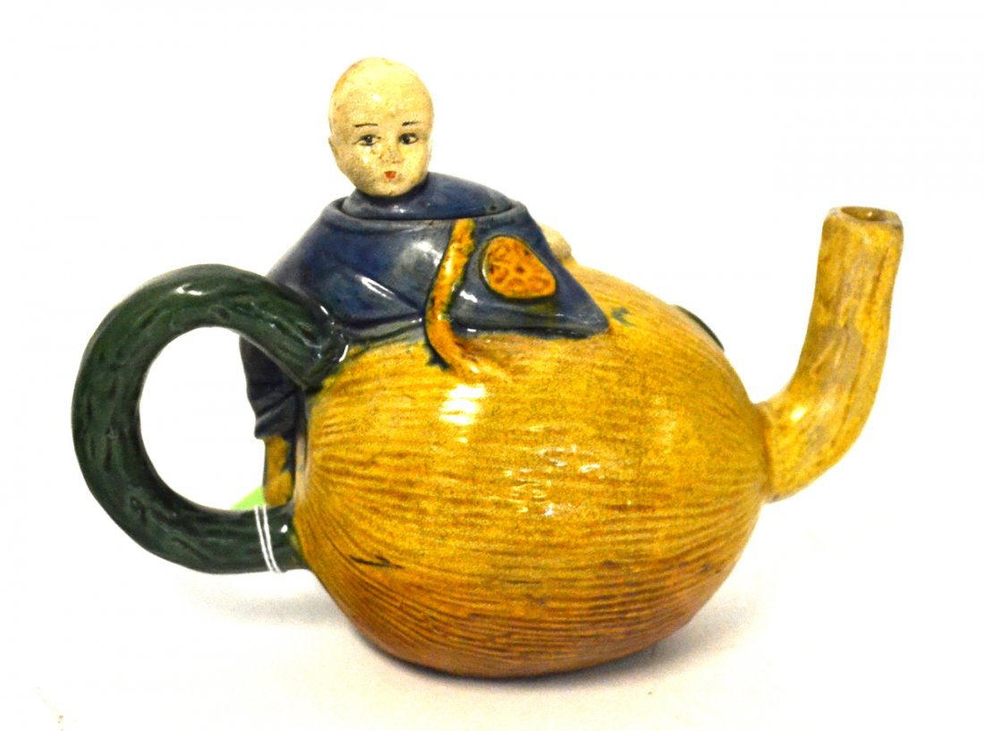 Chinese Tea Pot: In the form of a child astride a melon. [6 1/2" H].
