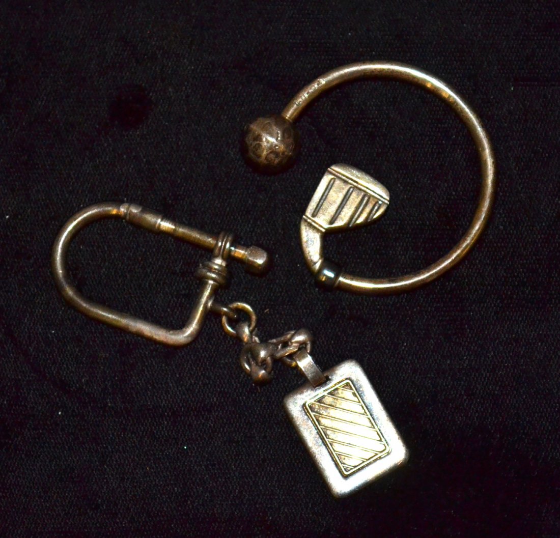 Two Silver Key Holders: Comprises: 1.) Gold club & ball key holder stamped: ".925 Mexico." 2.) .900 silver key holder with chain and fob bearing a 14K insert. Total 1.21 ozt.