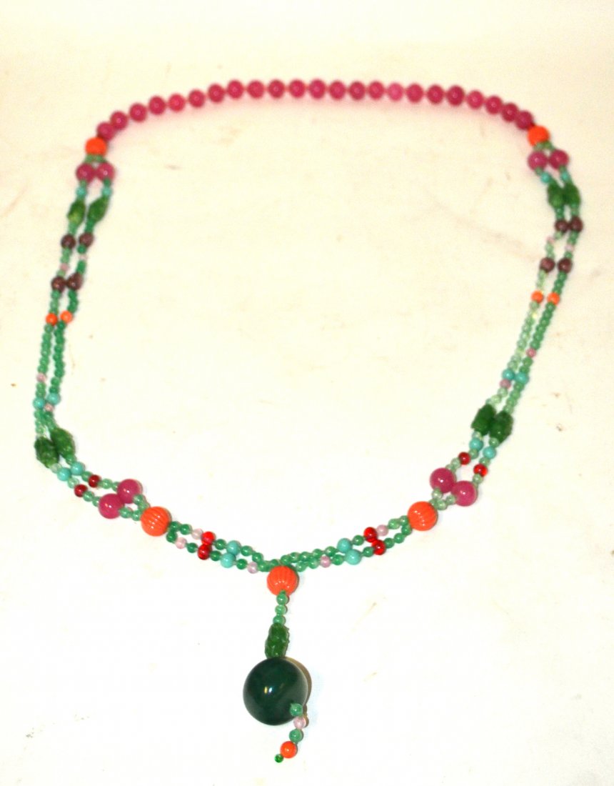 Yves Saint Laurent "Chinoiserie" Necklace: "Chinoiserie" emperors necklace. Composed of peking glass, Venetian glass, and resin. 60" long deep pink faux coral, faux green jade, rose quartz, faux turquoise, faux amethyst and faux tourmaline. Un