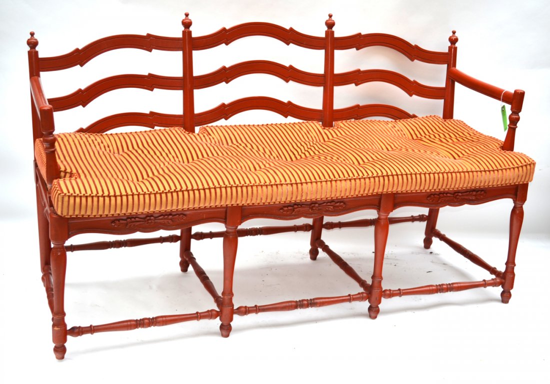 Red English Style Settee: Red settee with a rush seat, turned stretchers and urn form finials. [59"W x 19 1/2"D x 34 1/2"H (19"H to seat)]. Good condition.