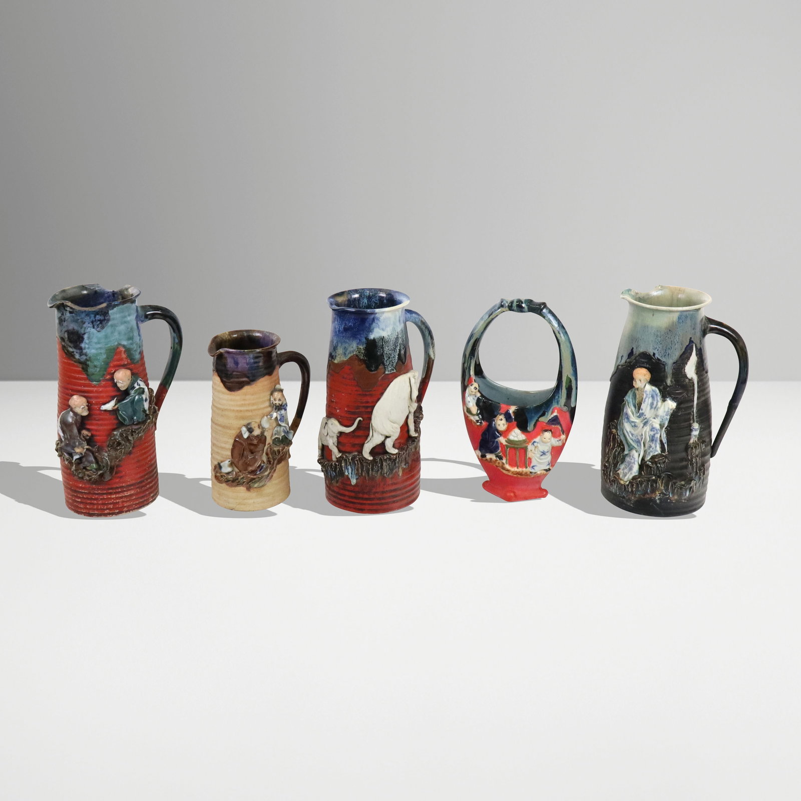 Chinese Mudware Large Articles, 5: Five Chinese large mudware / Shiwan / Sumida manner glazed and unglazed with elephants and mud men figures mounted on four pitchers, one basket vase. All but basket vase having a mounted signature.