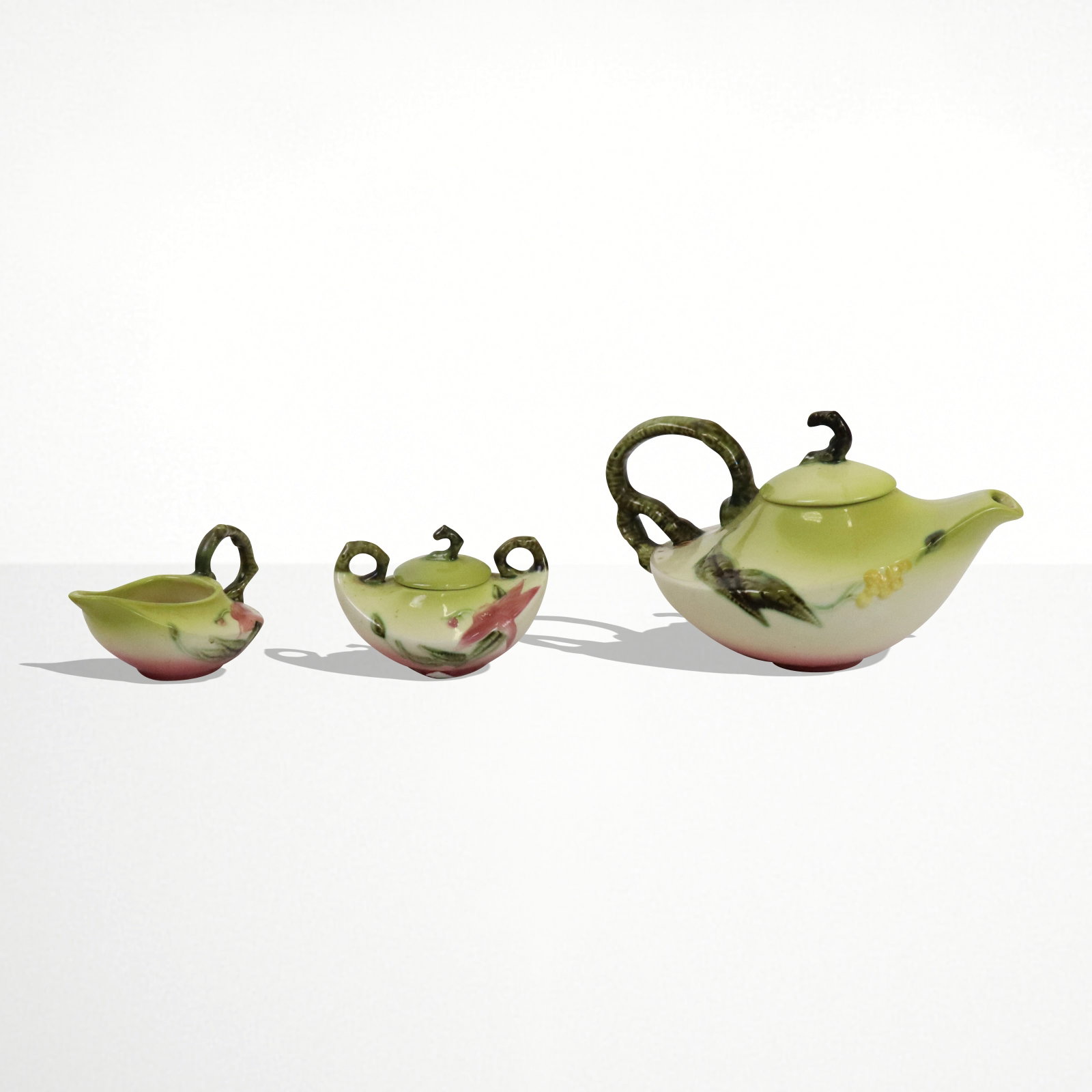 Hull Pottery Three Piece Set: Hull Pottery Three piece serving set, Woodland Pattern, Large Teapot (W26), creamer (W27) and covered sugar (W28). Hull American Pottery. [Teapot 7" H x 11" W x 7" D]. Good condition.