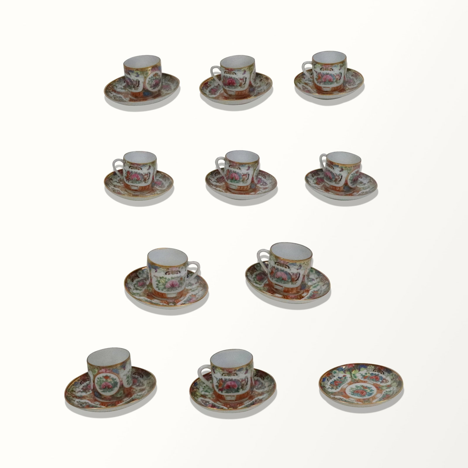 Rose Medallion Porcelain Demitasse Cups and Saucer: Rose Medallion porcelain demitasse cups and saucers, comprising 10 cups with 11 saucers, probably late 20th century, marks to reverse. [4.5" Diameter]. Overall condition is good, with little wear evid