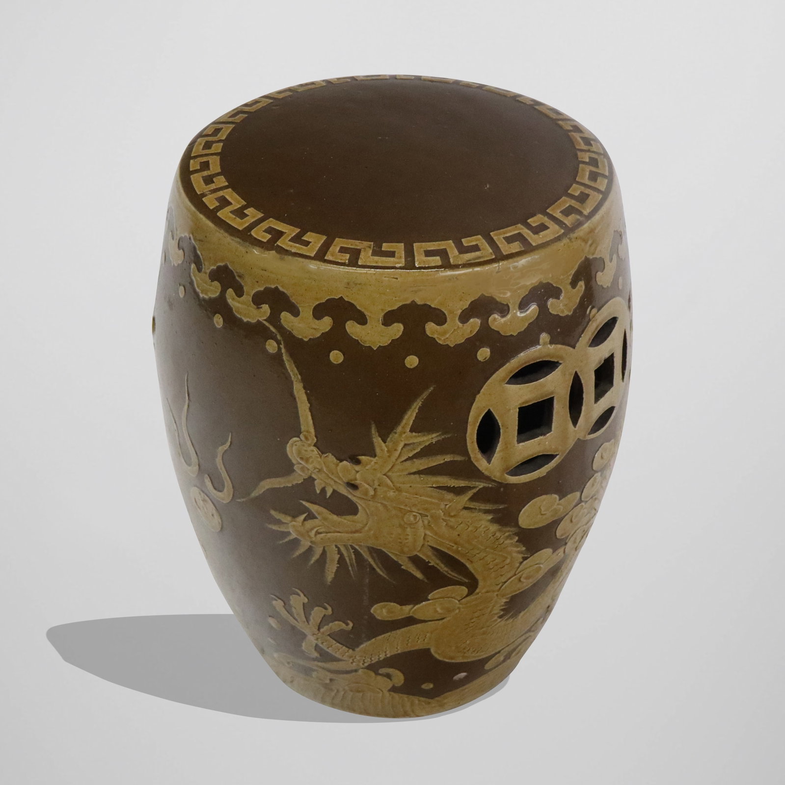 Chinese Ceramic Garden Seat: Chinese ceramic garden seat, two toned brown glaze, open circular handles with dragon and clouds designs. [17" H x 14" diameter]. Good condition.