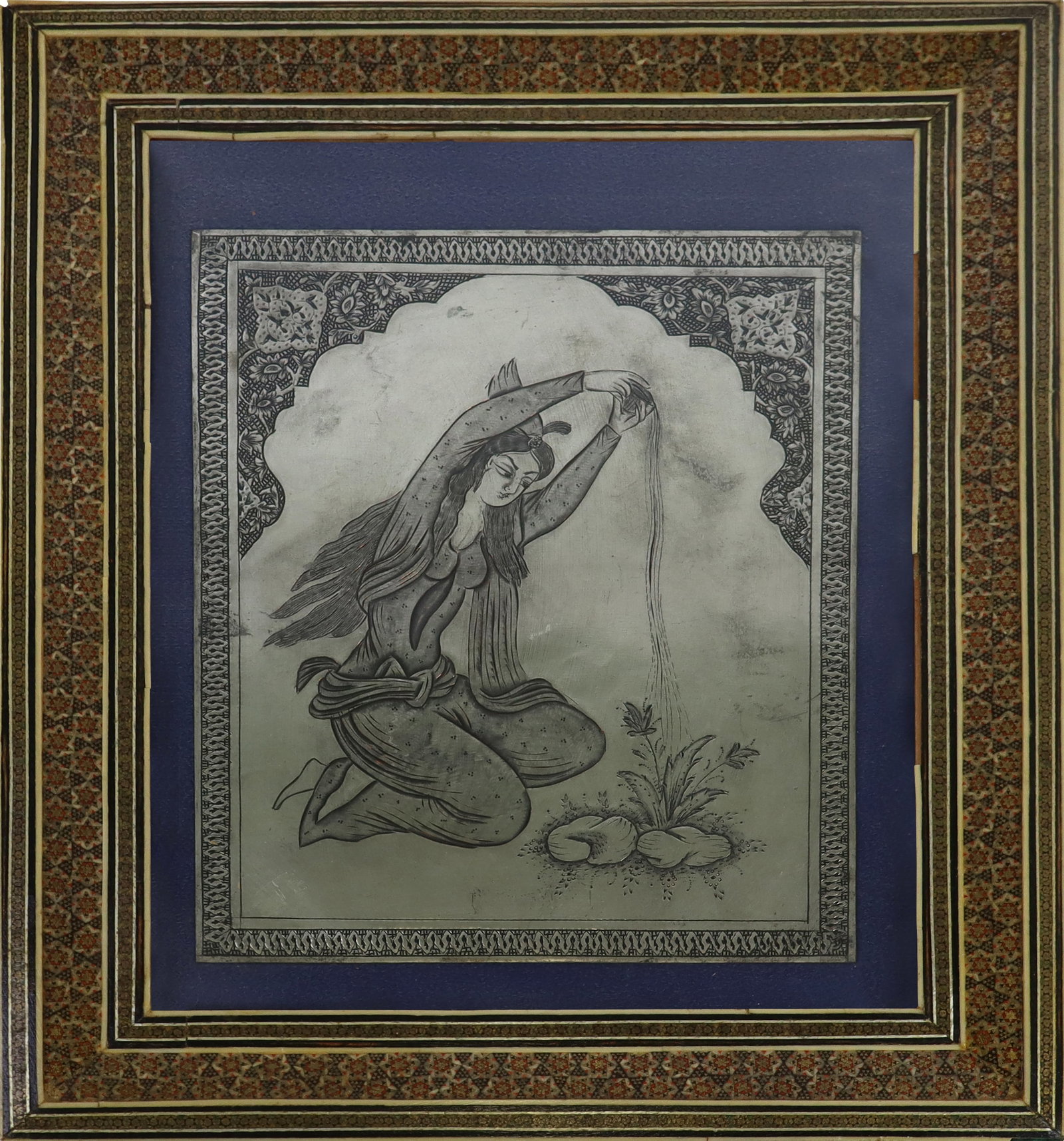 Framed Indian Silvered Metal Engraving: Framed Indian silvered metal engraving, depicting a woman watering a flower, with engraved border, within an inlaid picture frame. [Picture 9.5" x 8", Frame 15" x 12.5"]. Chips to frame.