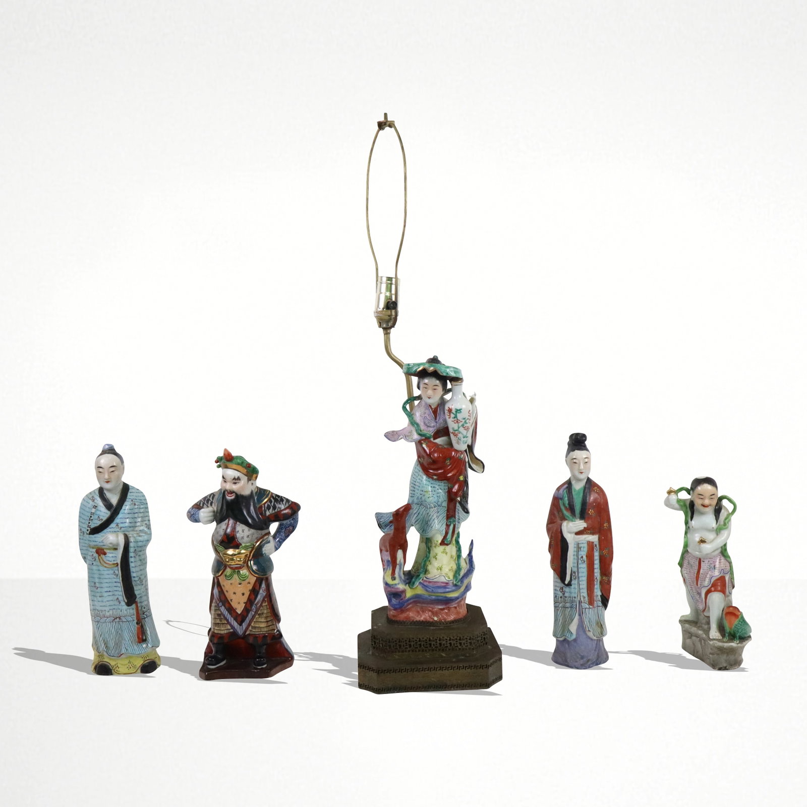Five Chinese Porcelain Figures: Five Chinese porcelain figures, one female figure with vase mounted as a lamp, the other 4 as single figures in various poses. 20th century. [Figure on lamp 14" H; with lamp 30" H]. Good condition.