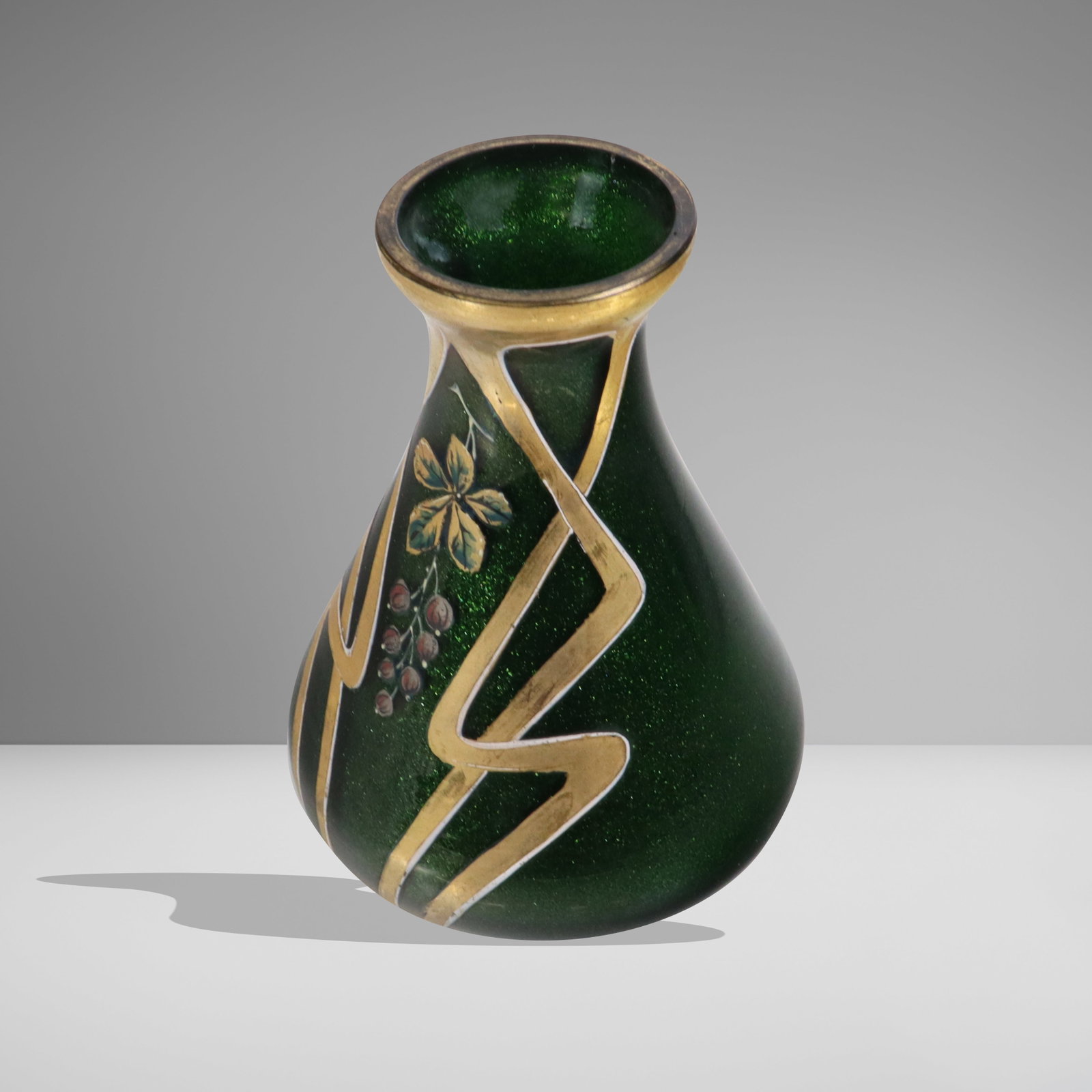 Art Glass Floral Decorated Vase: Art glass green vase, American, 20th century, with sparkle green interior and gilt decorated floral exterior. [5" H x 3.5" diameter]. Very tiny chip on interior rim