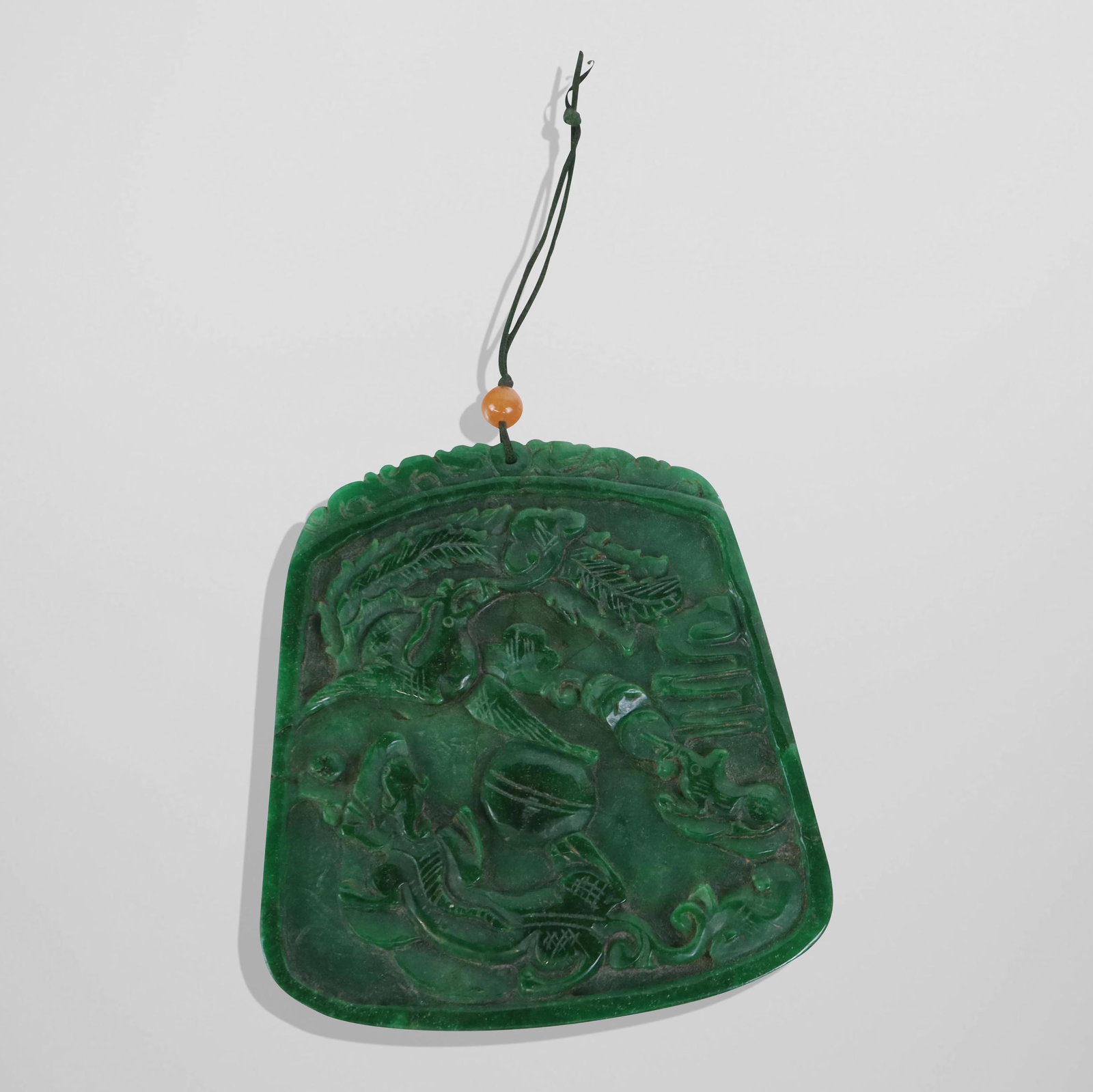 Large Chinese Jade Carved Pendant: Large Chinese Jade Carved Pendant, spinach colored deep green jade, double sided, with animal designs and a top lip crown. [4.25" H x 4" W]. Fine condition.