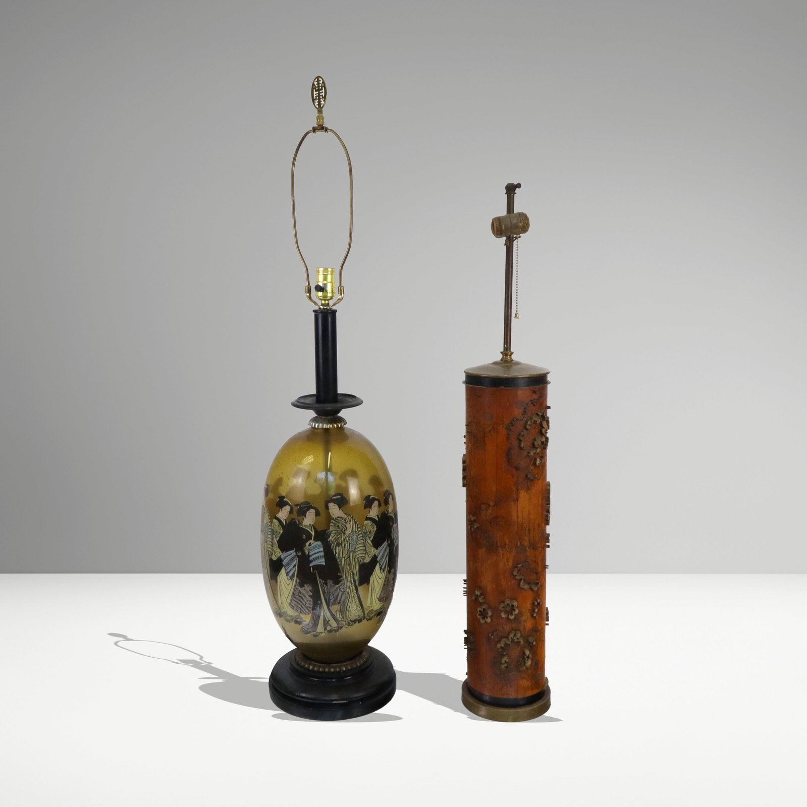 Two Tall Chinese Lamps: Two tall Chinese lamps, one smokey glass with reverse decorations of female figures, one as a printing scroll mounted as a columnar lamp. Both early 20th century. [roll 22" H, lamp 36" H]. Roll has a 