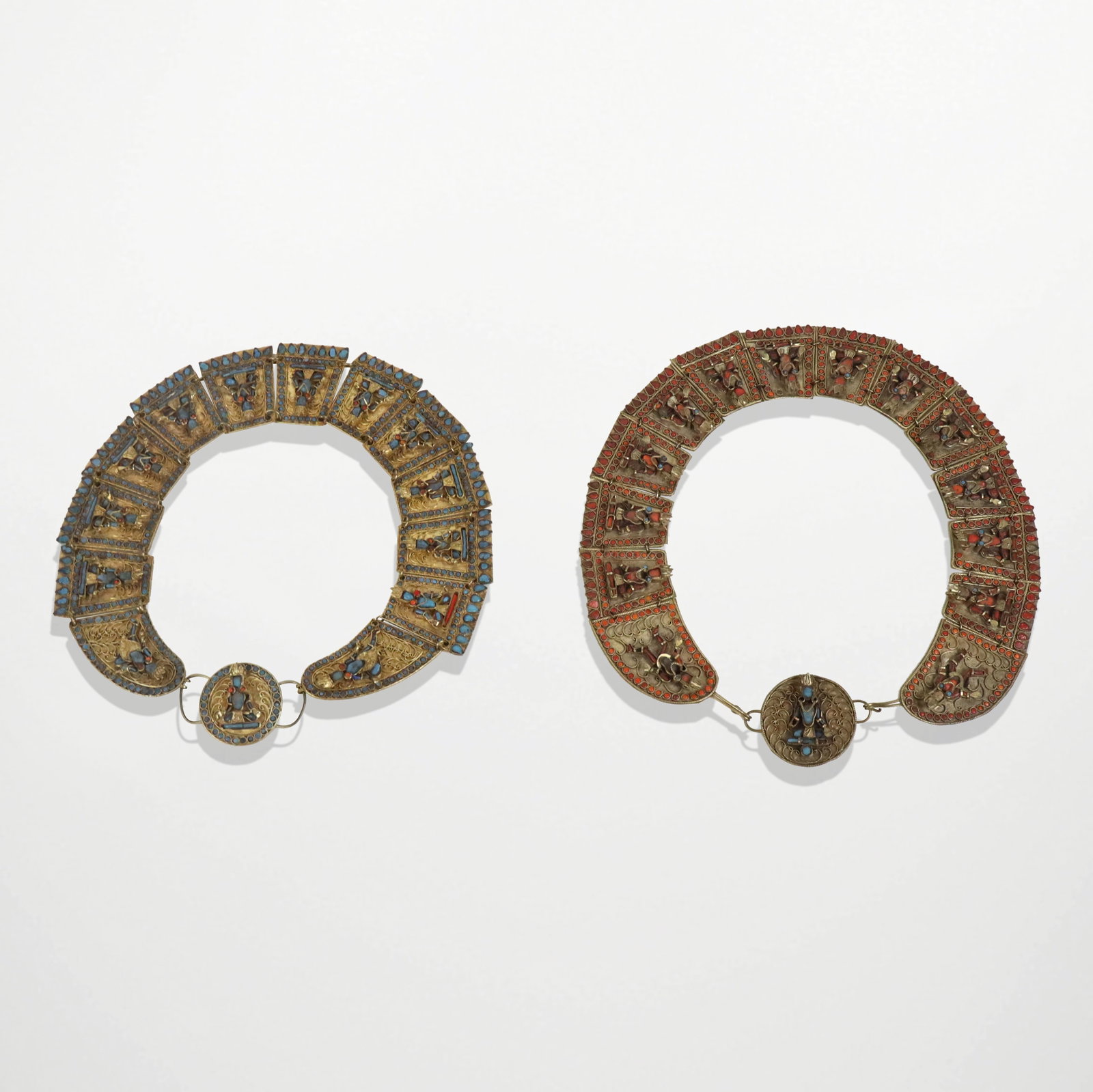 Two Vintage Tibetan Collars: Two vintage turquoise- and coral-colored stone, glass and enamel necklaces, each composed of wedge shaped wirework decorated links depicting Buddha, probably Tibetan, unsigned. [18" L]. Overall condit
