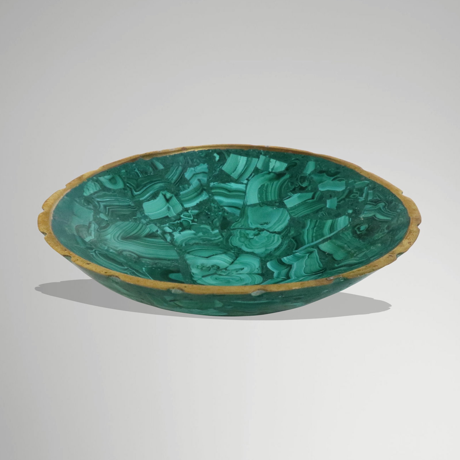 Malachite Carved Dish: Malachite and gilt metal dish, unmarked. [1" H x 5.25" Diameter]. Overall condition is good, with minor loss to gilt rim.