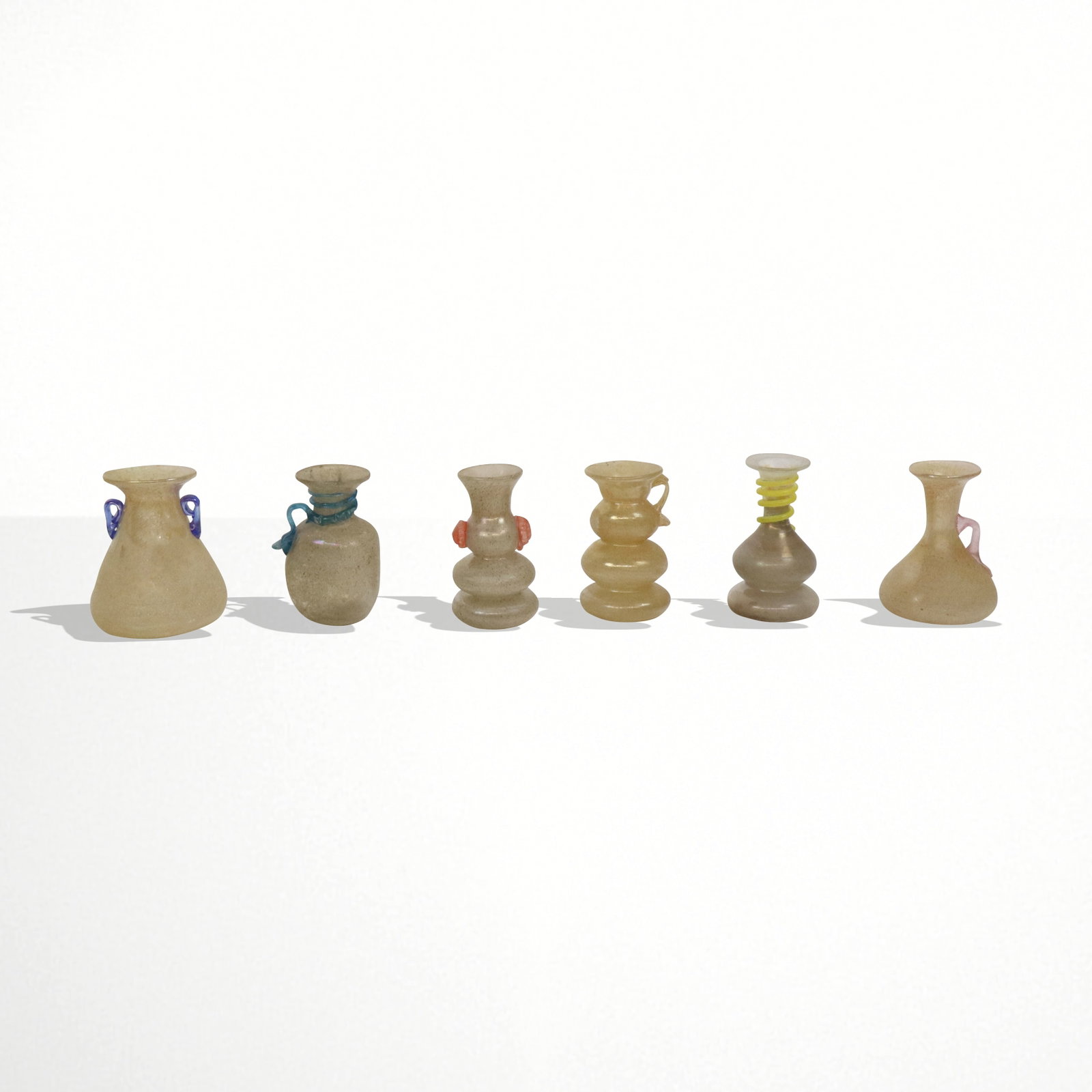 Roberto Ducci Ancient Style Art Glass Vases, 6: Collection of Tuscan / Venetian ancient art glass vases, 20th/21st century vases, variously designed, the brown speckled vases accented with variously colored or iridescent accents, four bearing paper
