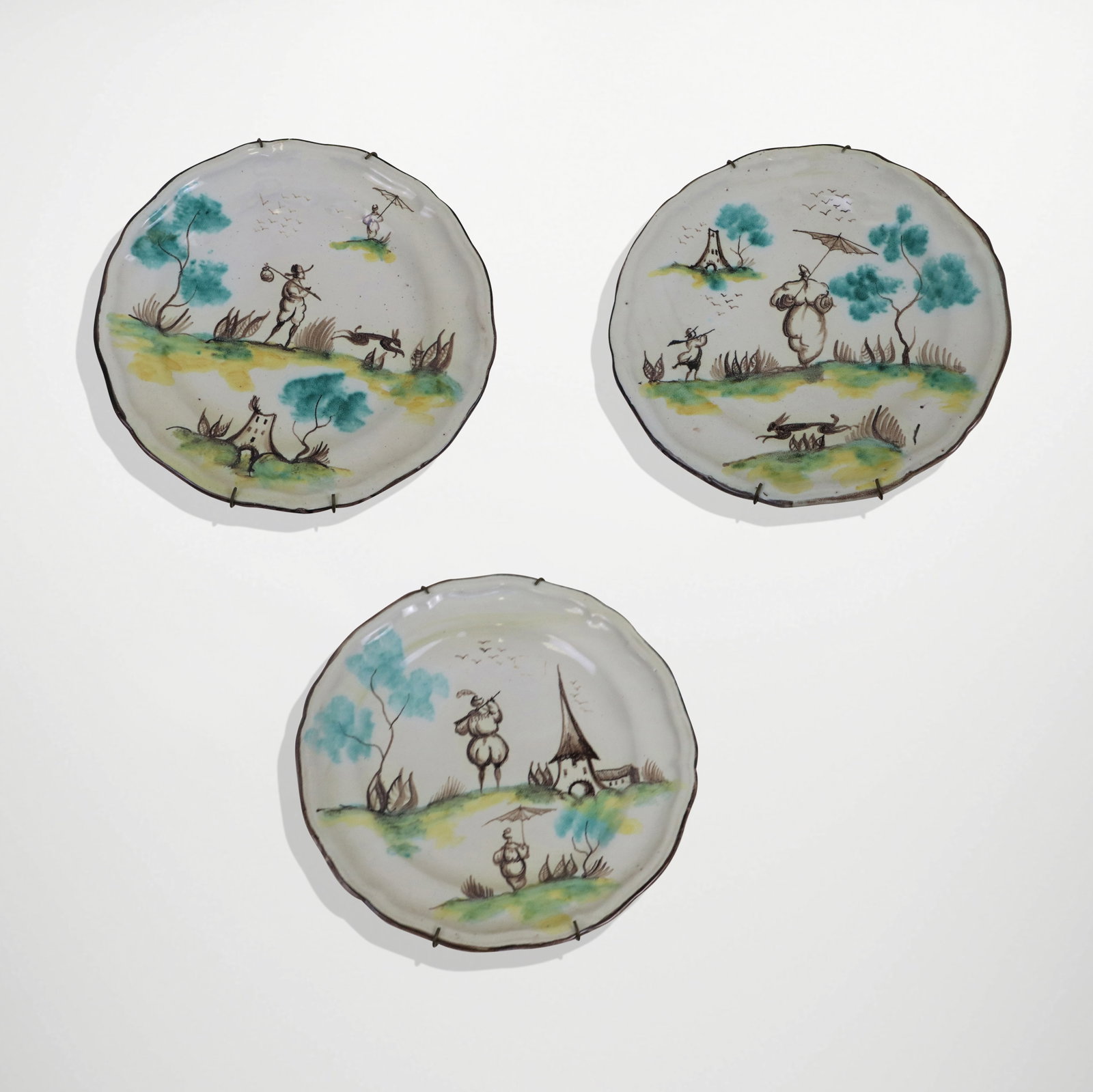 Set of Italian Majolica Fenice Albisola Plates, 3: Set of 3 Italian Majolica Fenice Albisola plates, underglaze views of a man and woman in countryside scenes, in colors, early 20th century. [8.5" diameter]. Good condition.