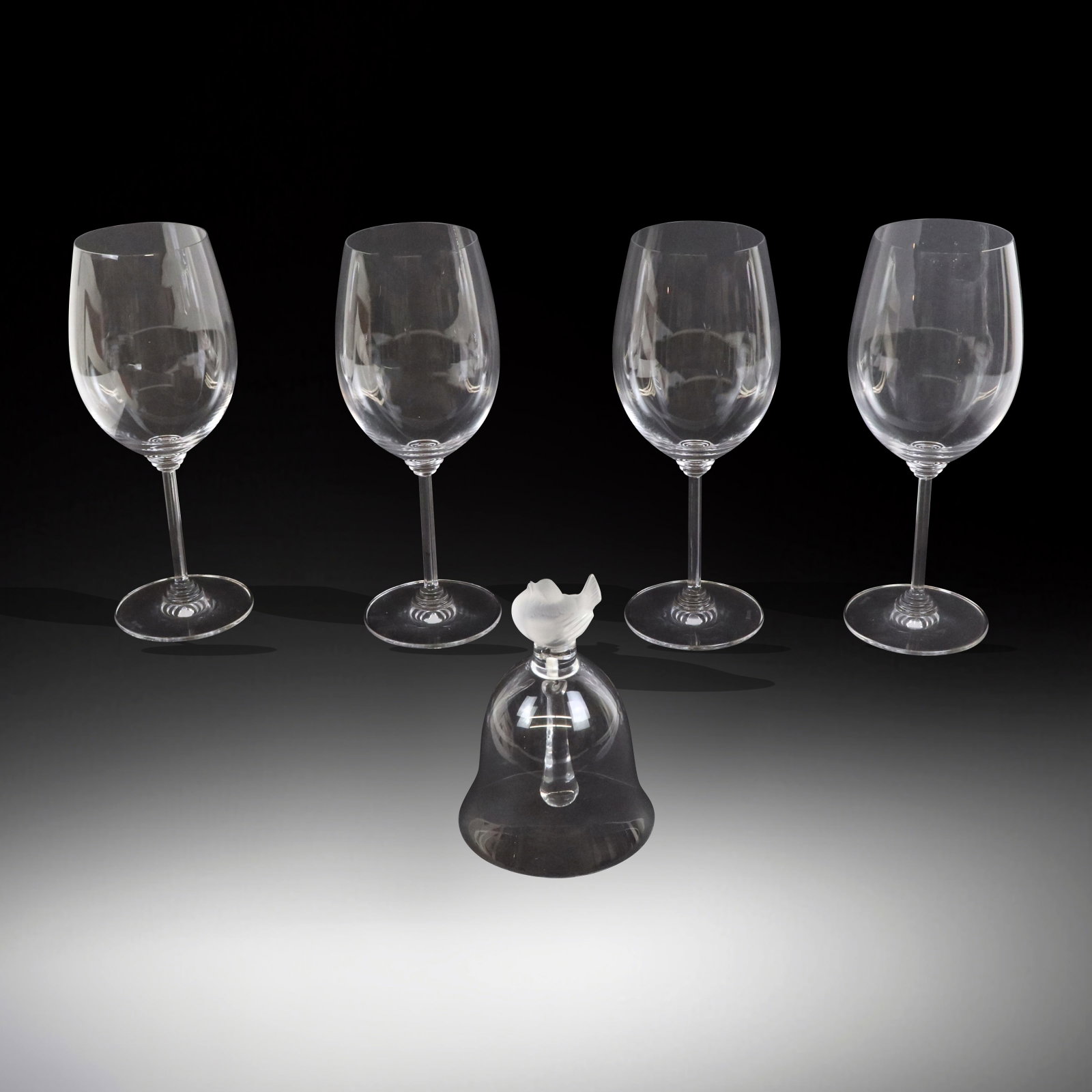 Lalique & Ridel Glass Accessories, 5: Collection of European glassware, comprising four Riedel "Pantheon" pattern red wine glasses [9.25" H x 3.25" Diameter], and a Lalique satin and polished glass sparrow decorated bell [5.5" H x 3.5" W]