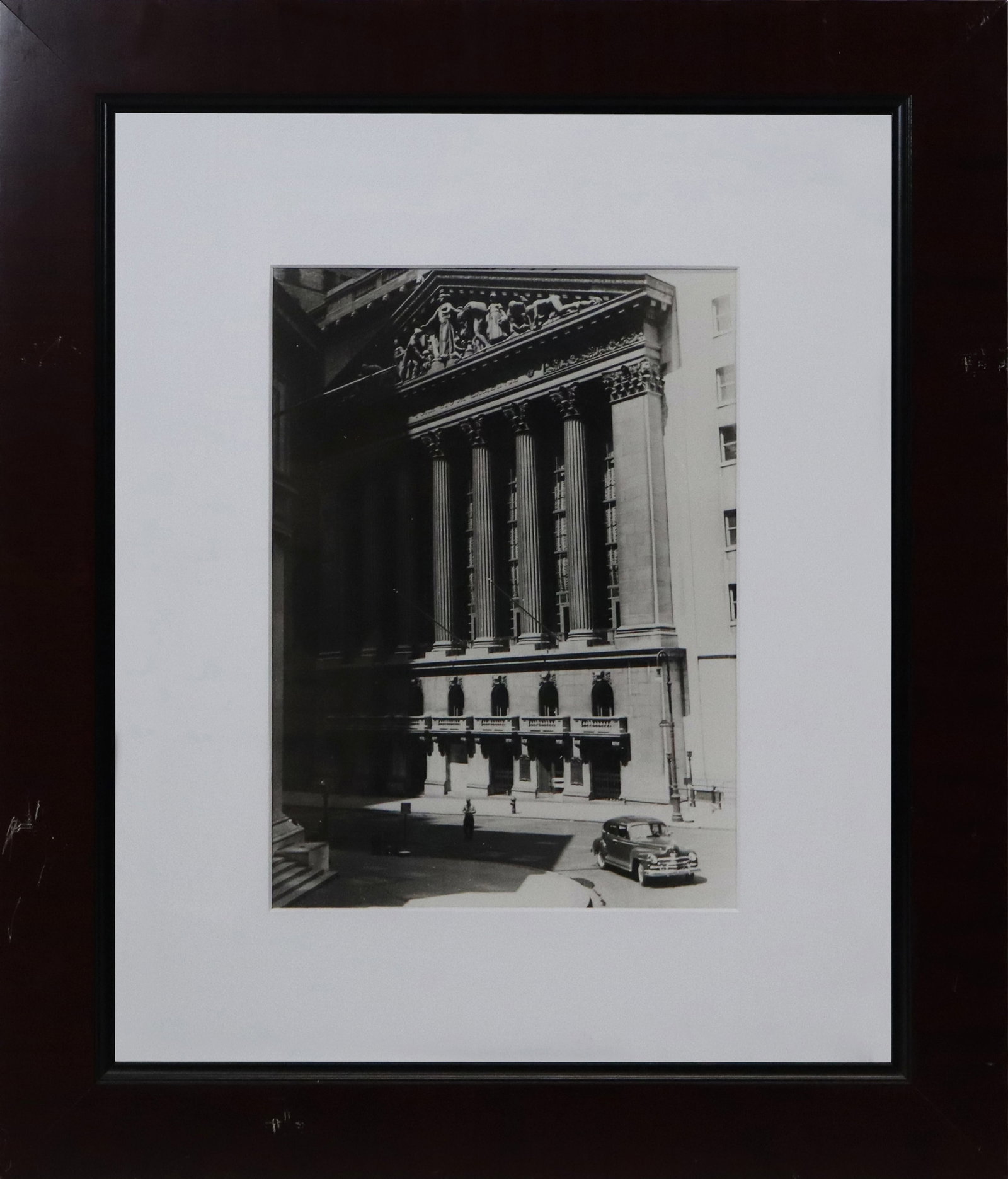 Vintage Photo Print of NY Stock Exchange: Vintage Photo print of New York Stock exchange, with a vintage car in front, unsigned, reproduction. [sight 12.5" H x 9" W; frame 23" H x 20" W]. Fine condition, frame scratched, not removed from fram
