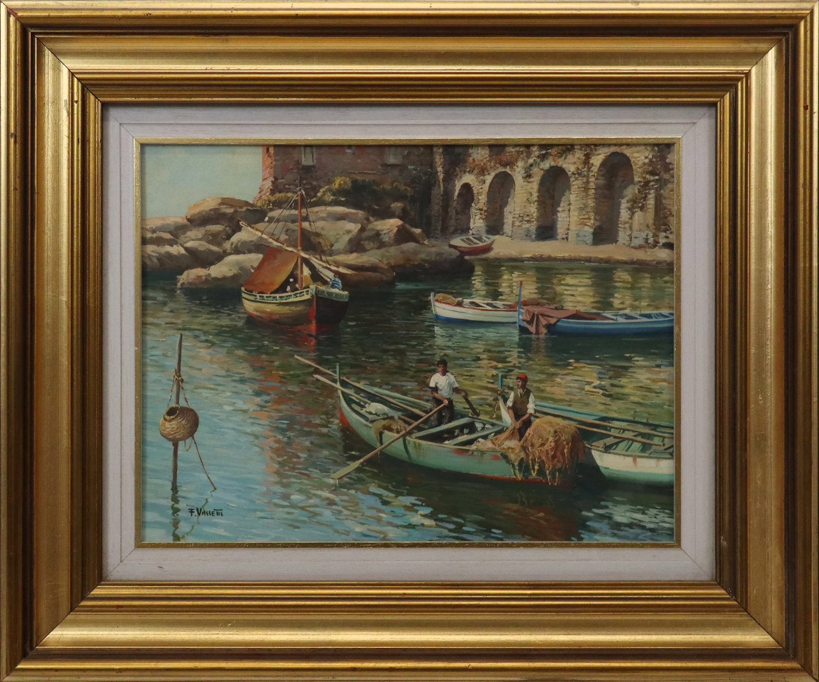 Francesco VASSETTI Oil on Panel Coastal Scene: Francesco Vassetti (Italian, 1936-2020) gilt framed oil on panel depicting a rocky Italian coastal scene with figures in boats, signed lower left "F. Vassetti" and to reverse of frame, bearing label f