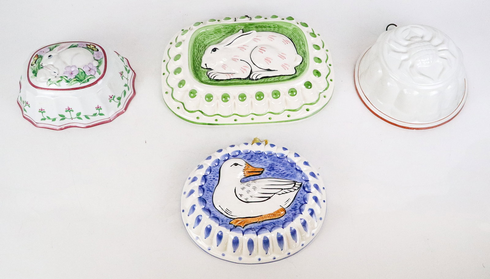 Four Porcelain Mold Form Wall Appliques: Four porcelain wall appliques in the form of molds, 21st century, comprising one with a duck, one with a crab, and two differently styled rabbits. [Largest: 9" H x 12" W x 3" D]. Condition throughout 