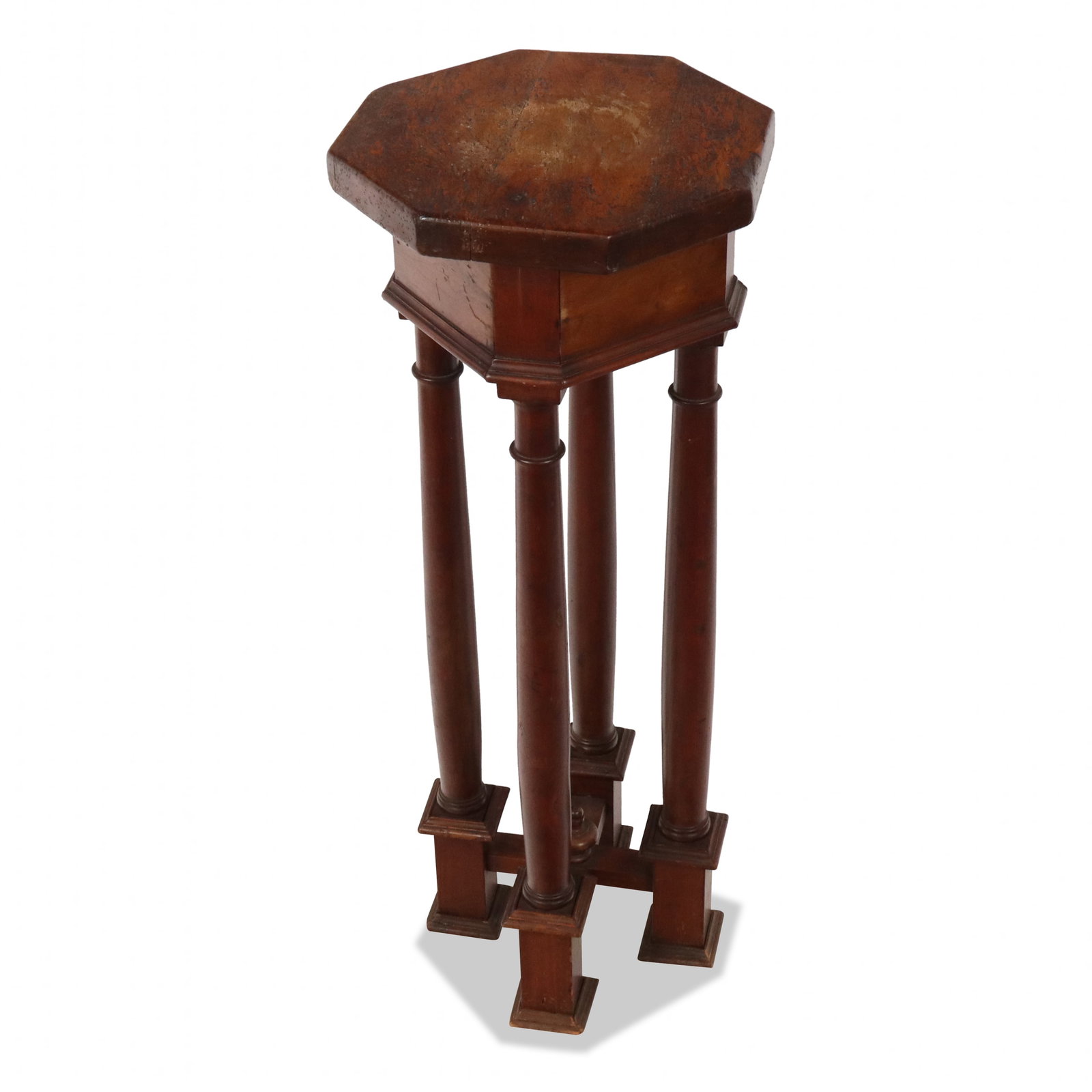 Gothic Revival Walnut Pedestal: Gothic Revival walnut pedestal, 19th century, with four column form supports joined at base by a cross stretcher, and an octagonal top. [45" H x 18" Diameter]. Condition is good with some surface wear