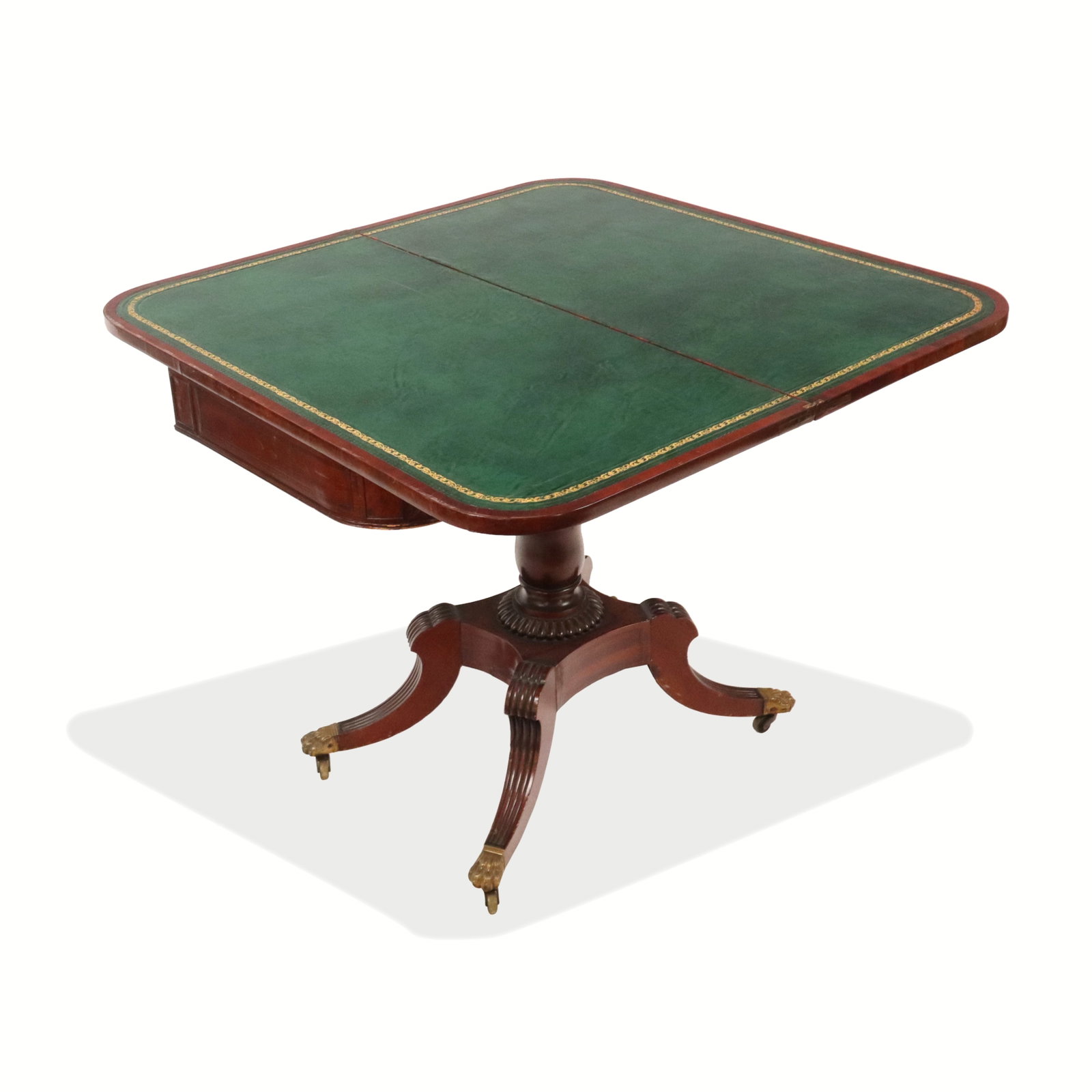 Regency Mahogany Flip-Top Games Table: Regency mahogany flip-top games table, 19th century, with inlay to outer border, opening to reveal a later green leather surface to interior, and supported by a carved lower and terminating in brass c