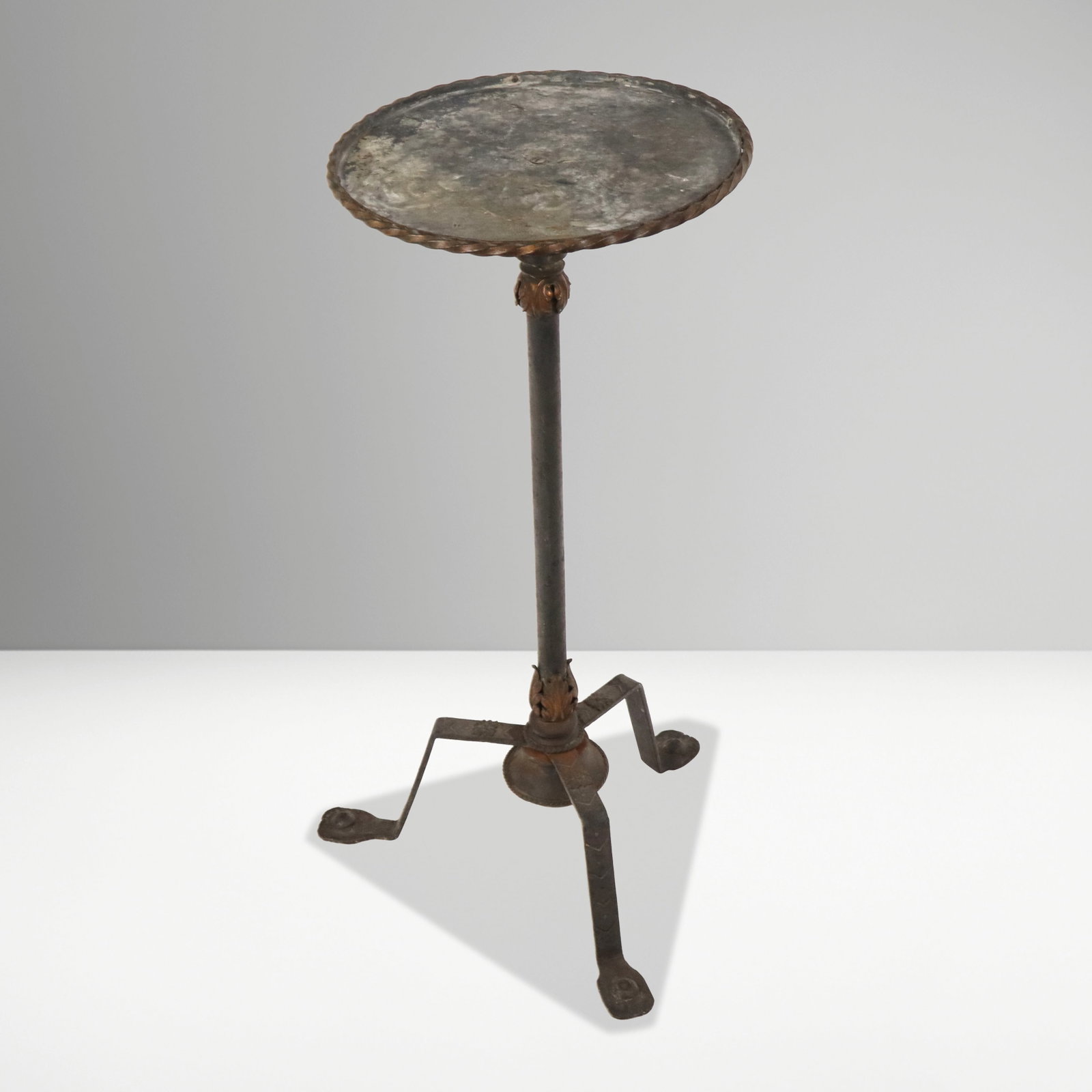 Spanish Metal and Parcel Gilt Pedestal: Spanish metal and parcel gilt pedestal, 20th century, with details to support and pressed metal legs. [29.5" H x 12.5" Diameter]. Condition is good with surface wear.