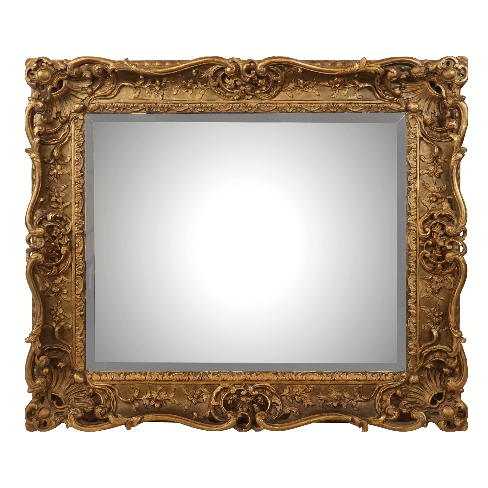 Antique Gilt Wood Carved Beveled Mirror: Antique gilt wood carved beveled mirror with scrolling foliate and shell border. [39" H x 34" W]. Overall condition is good, some losses and wear.